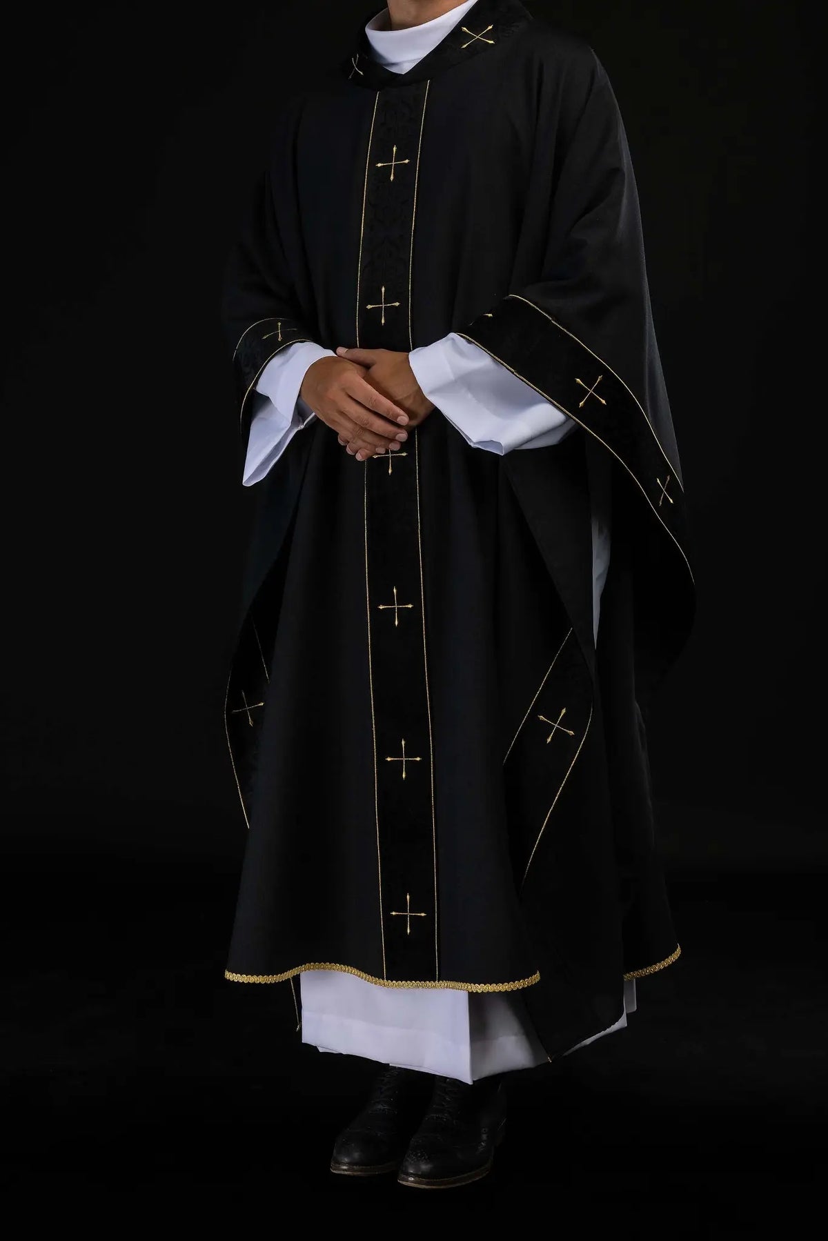 Black chasuble with gold crosses, three-quarter worn view