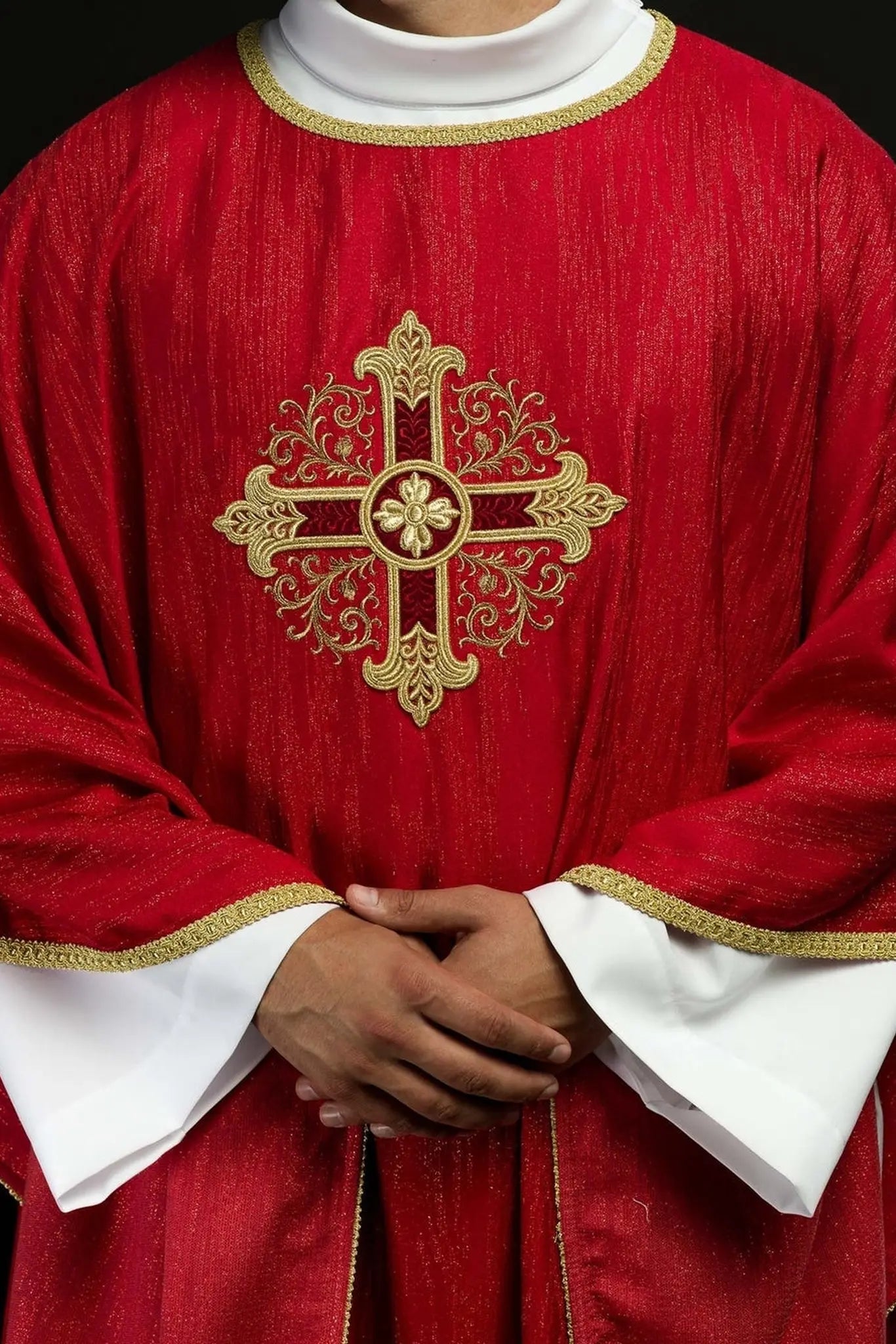 Red chasuble with embroidered cross motif on decorative fabric