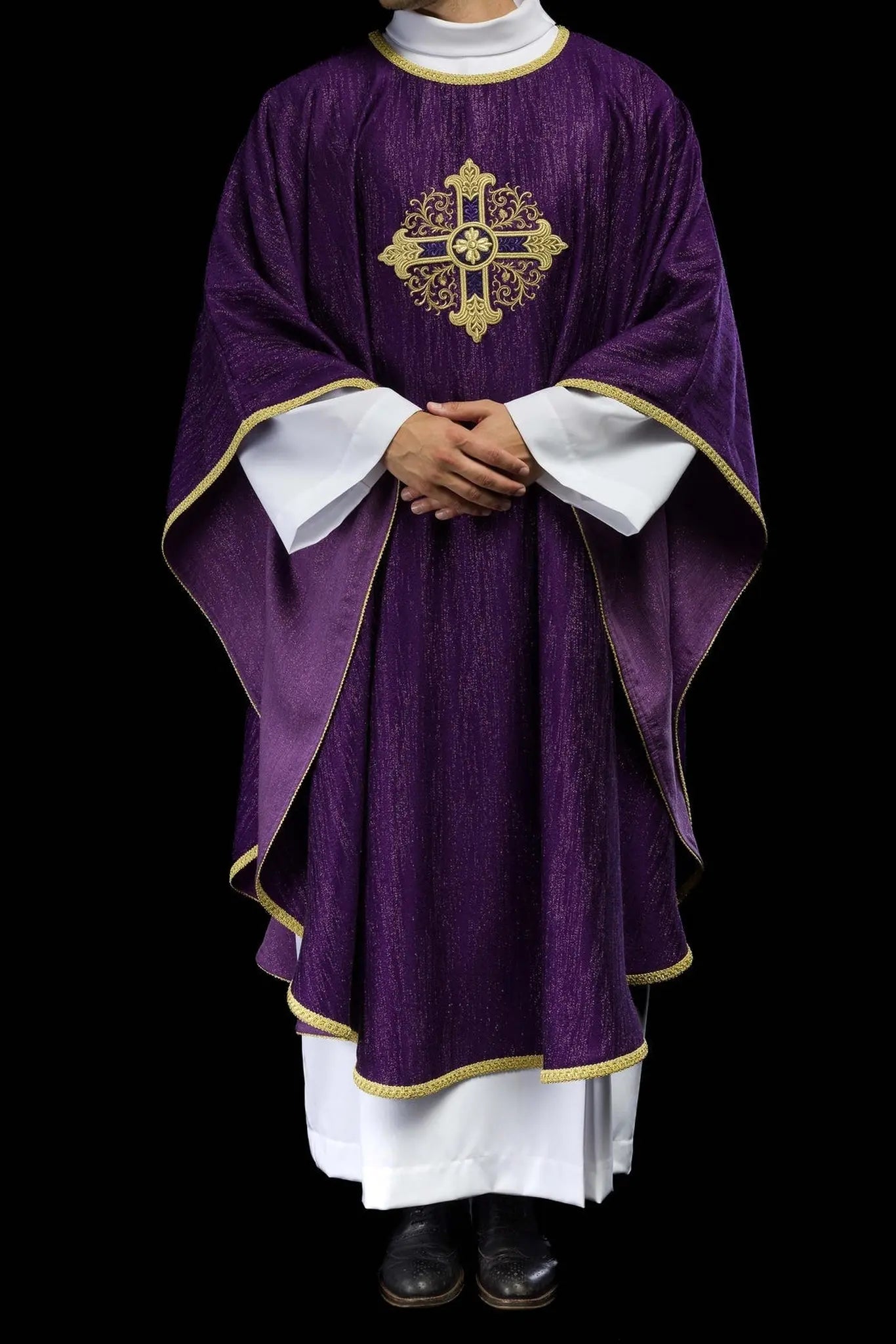 Purple liturgical chasuble with an embroidered cross motif on decorative fabric