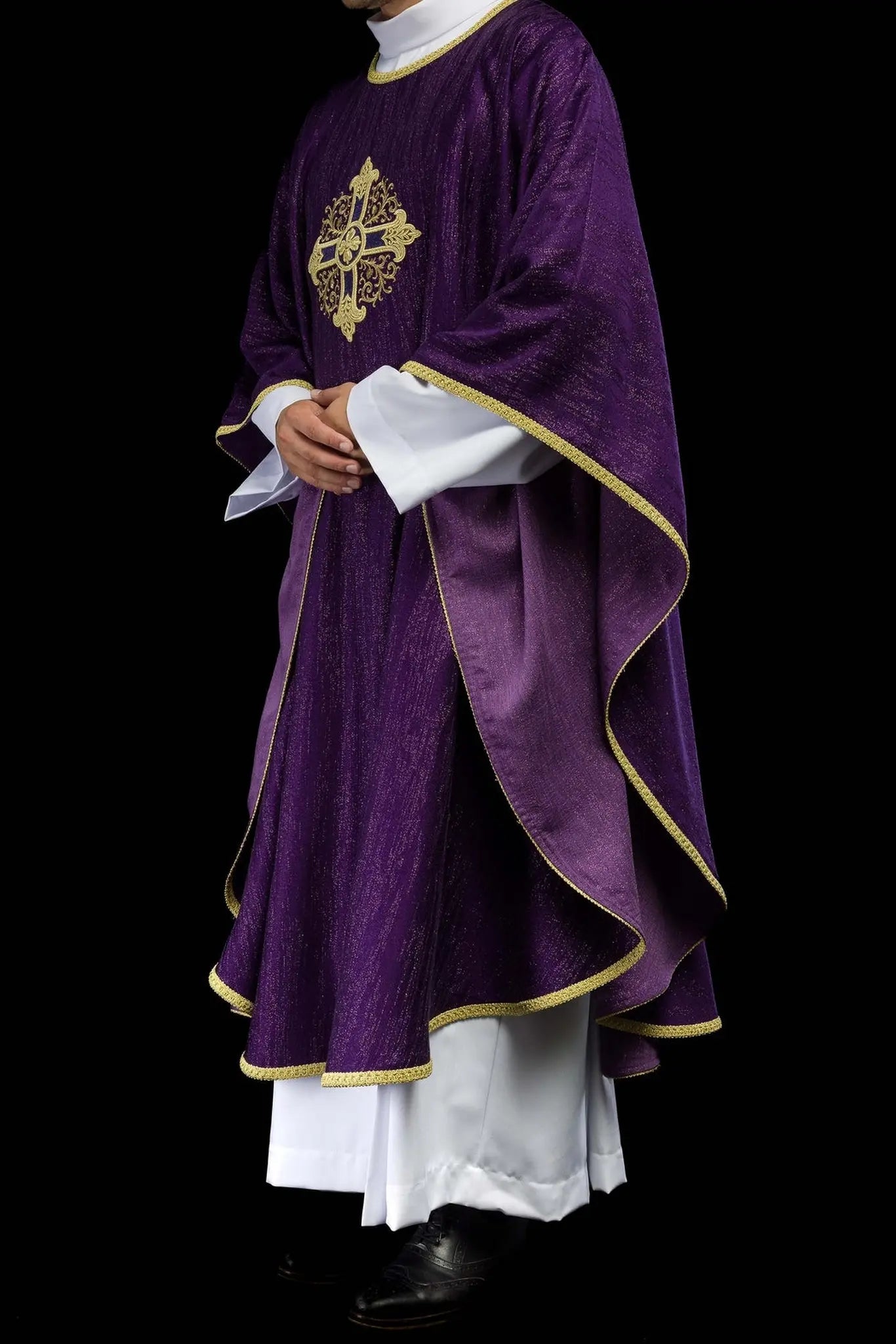 Purple liturgical chasuble with an embroidered cross motif on decorative fabric