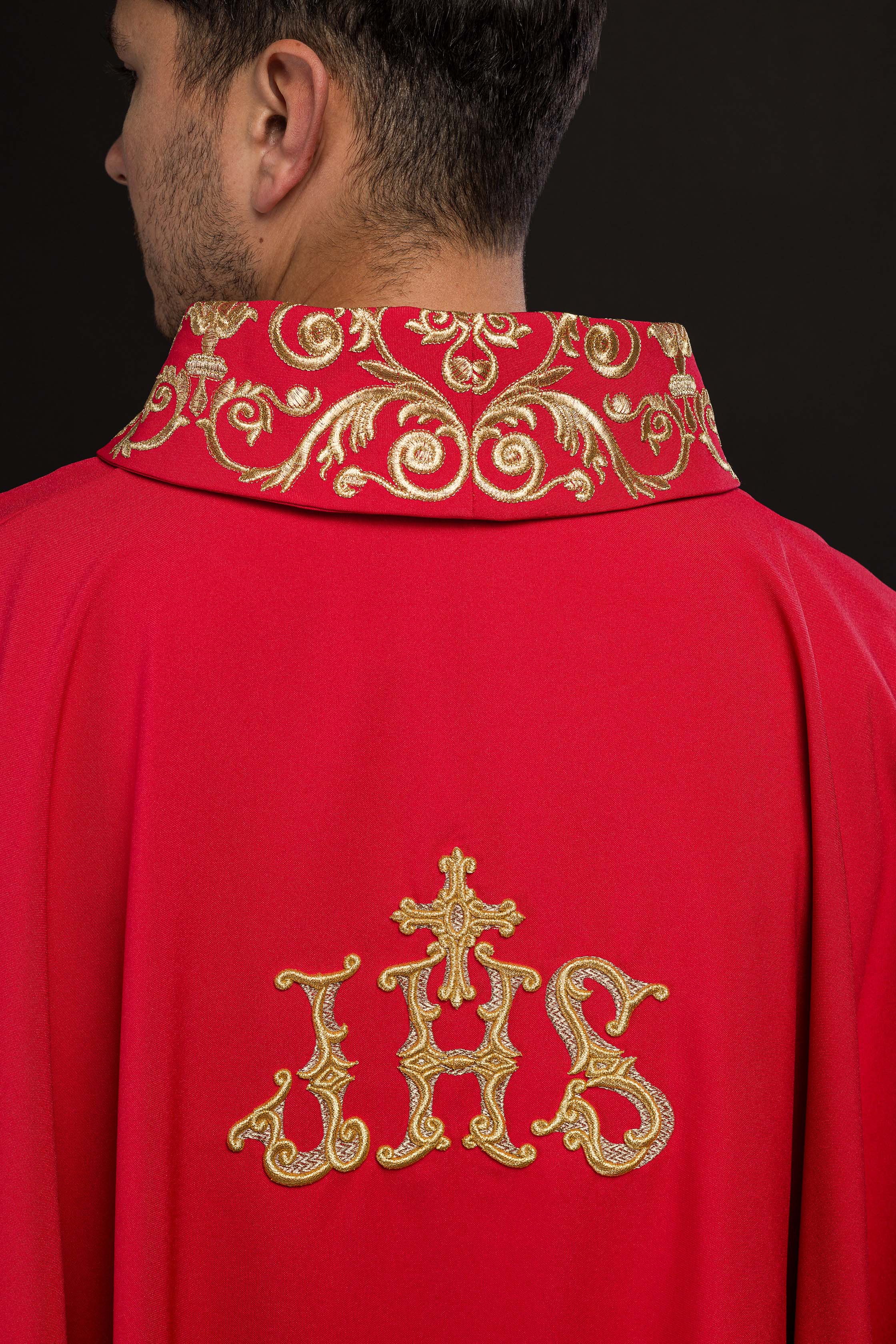Red chasuble with gold IHS embroidery and decorative trim