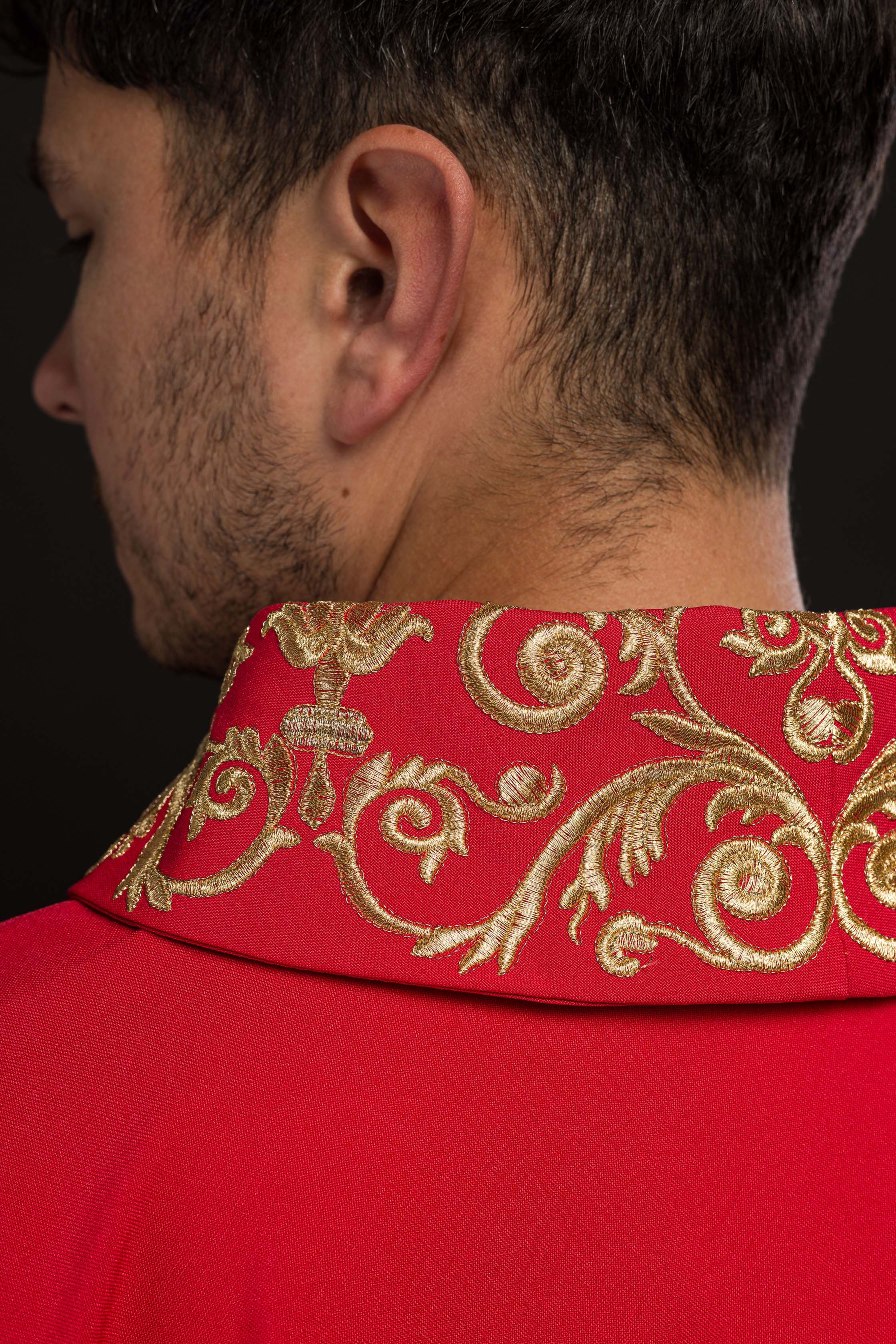 Red chasuble with gold IHS embroidery and decorative trim