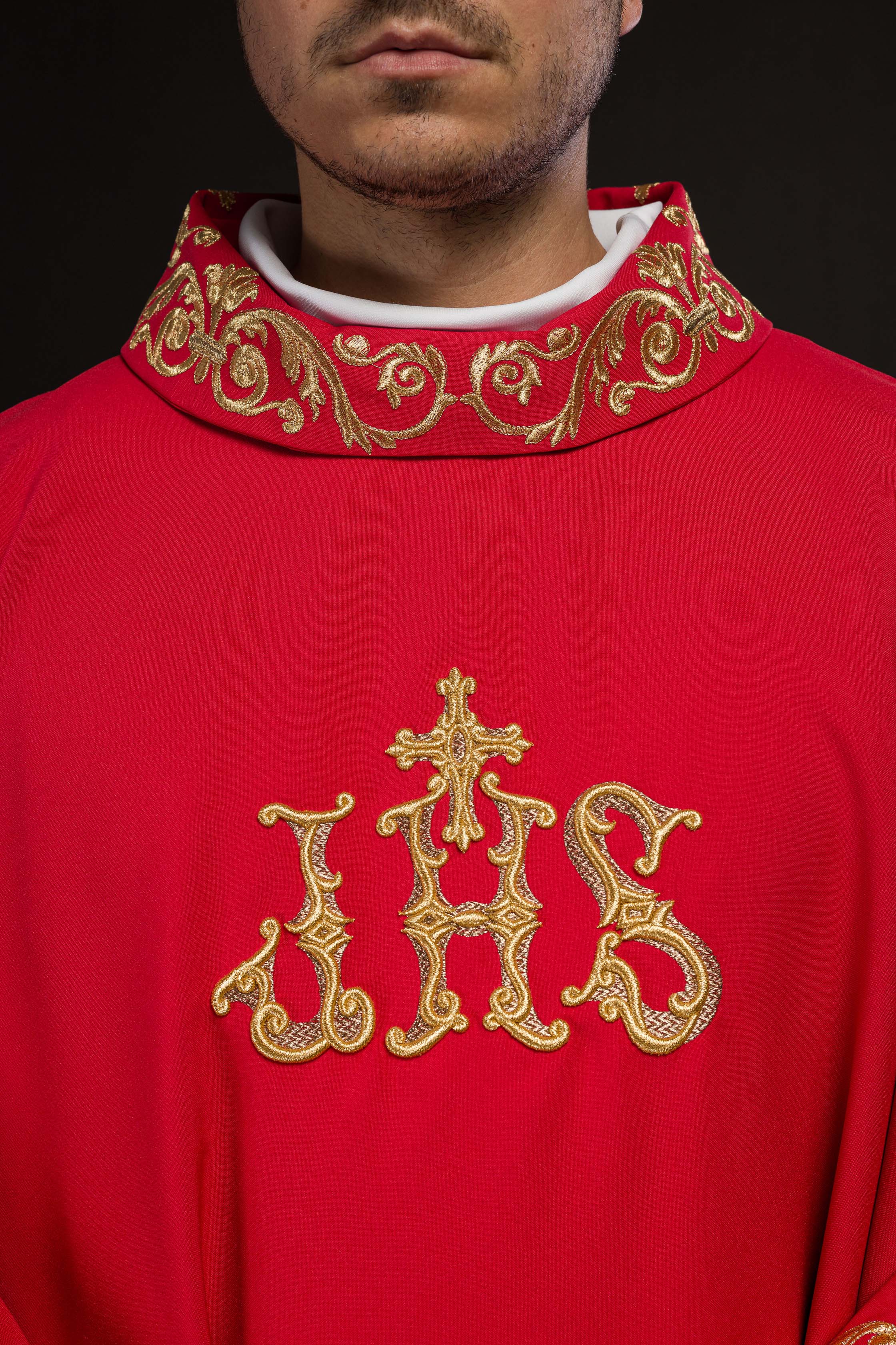 Red chasuble with gold IHS embroidery and decorative trim