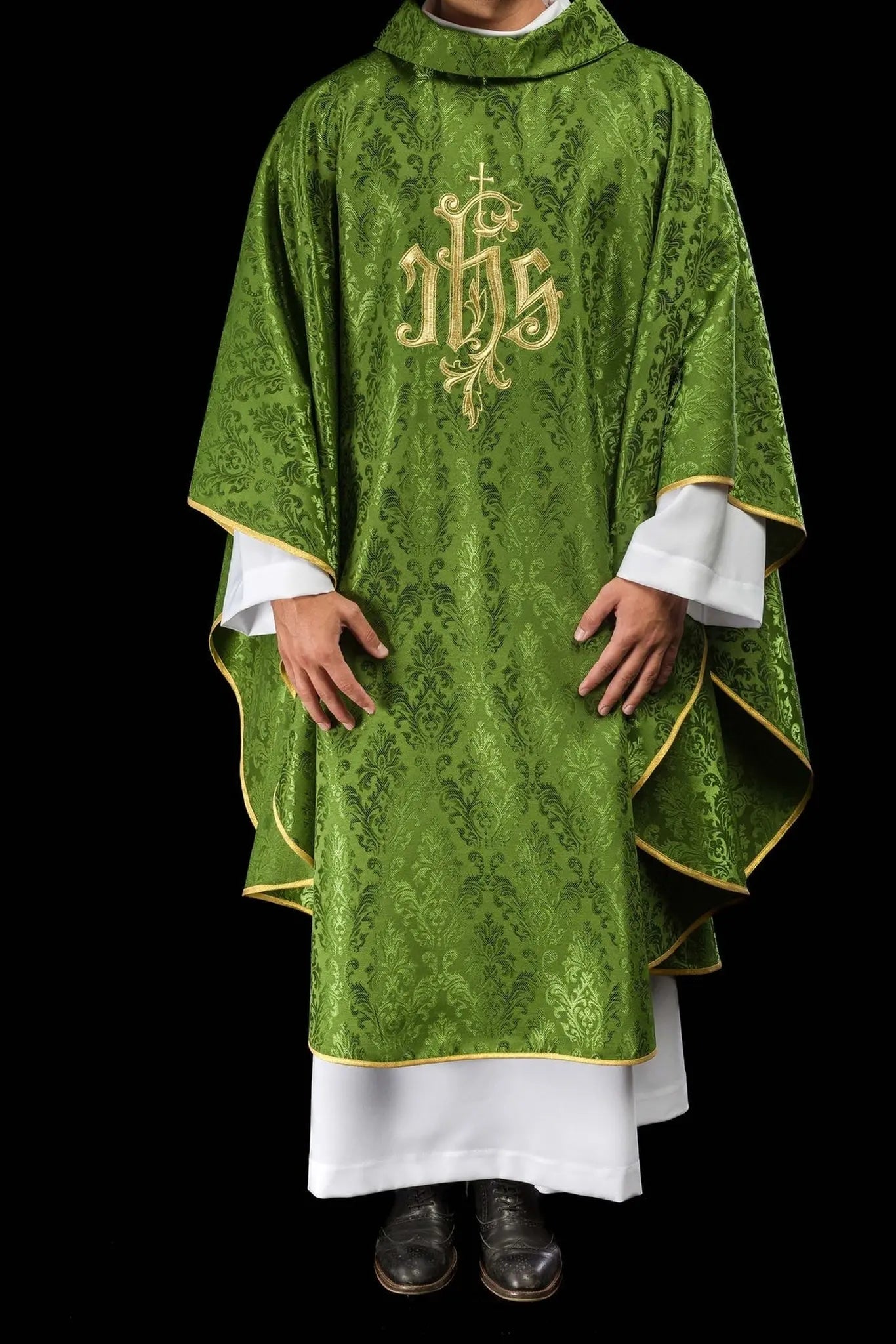 Green chasuble with embroidered IHS motif on decorative fabric
