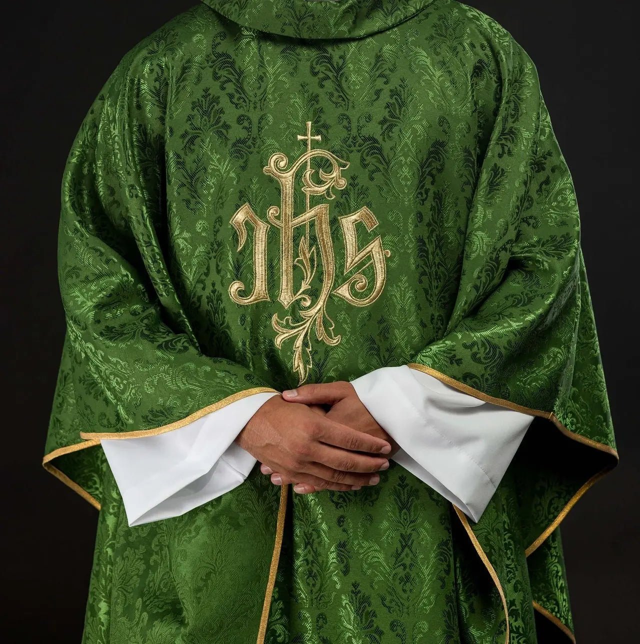 Green chasuble with embroidered IHS motif on decorative fabric