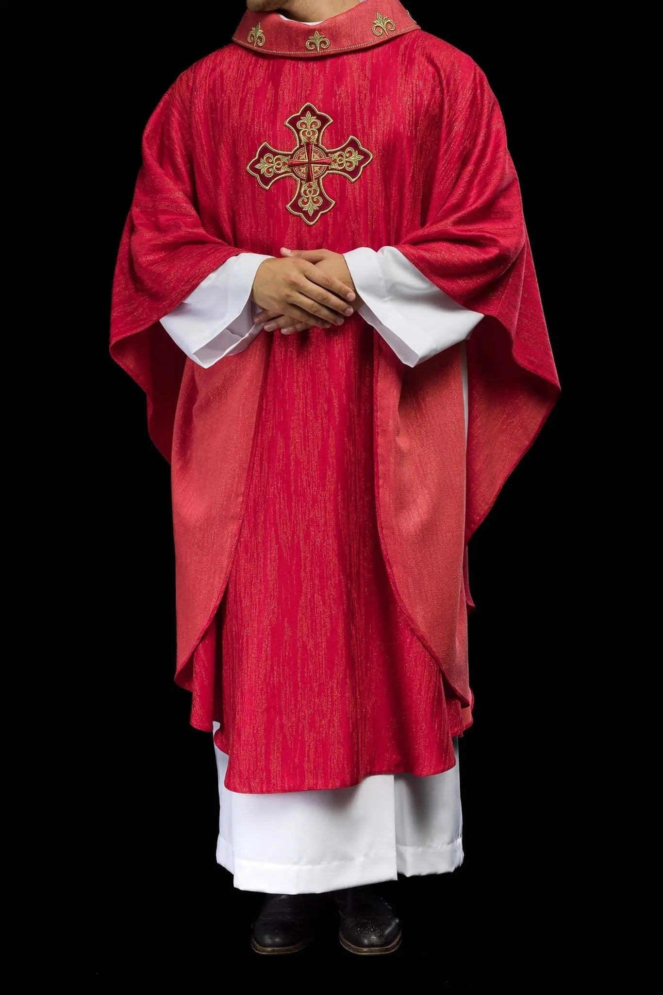 Red chasuble with embroidered cross motif on decorative fabric