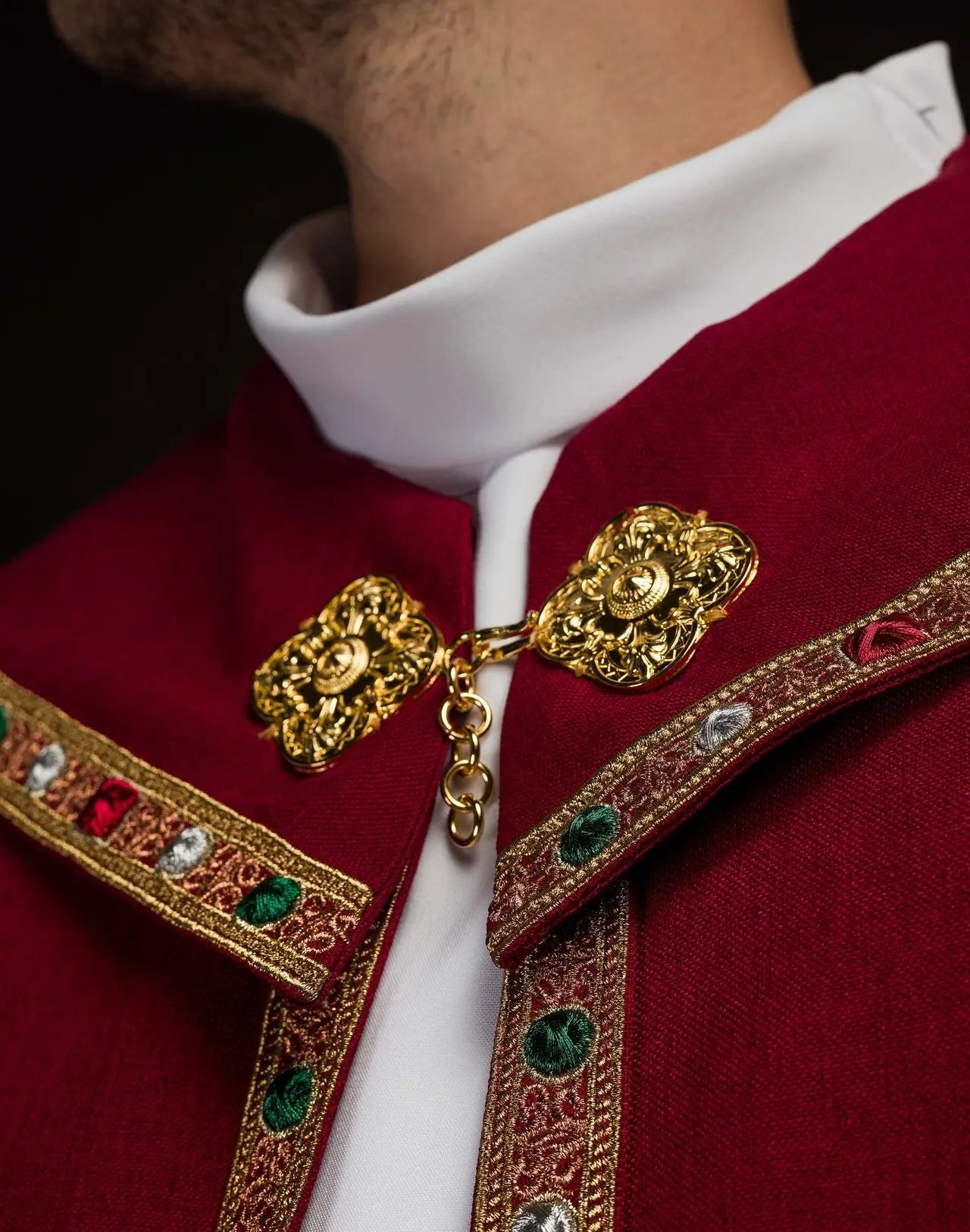 Red liturgical cape with gold IHS