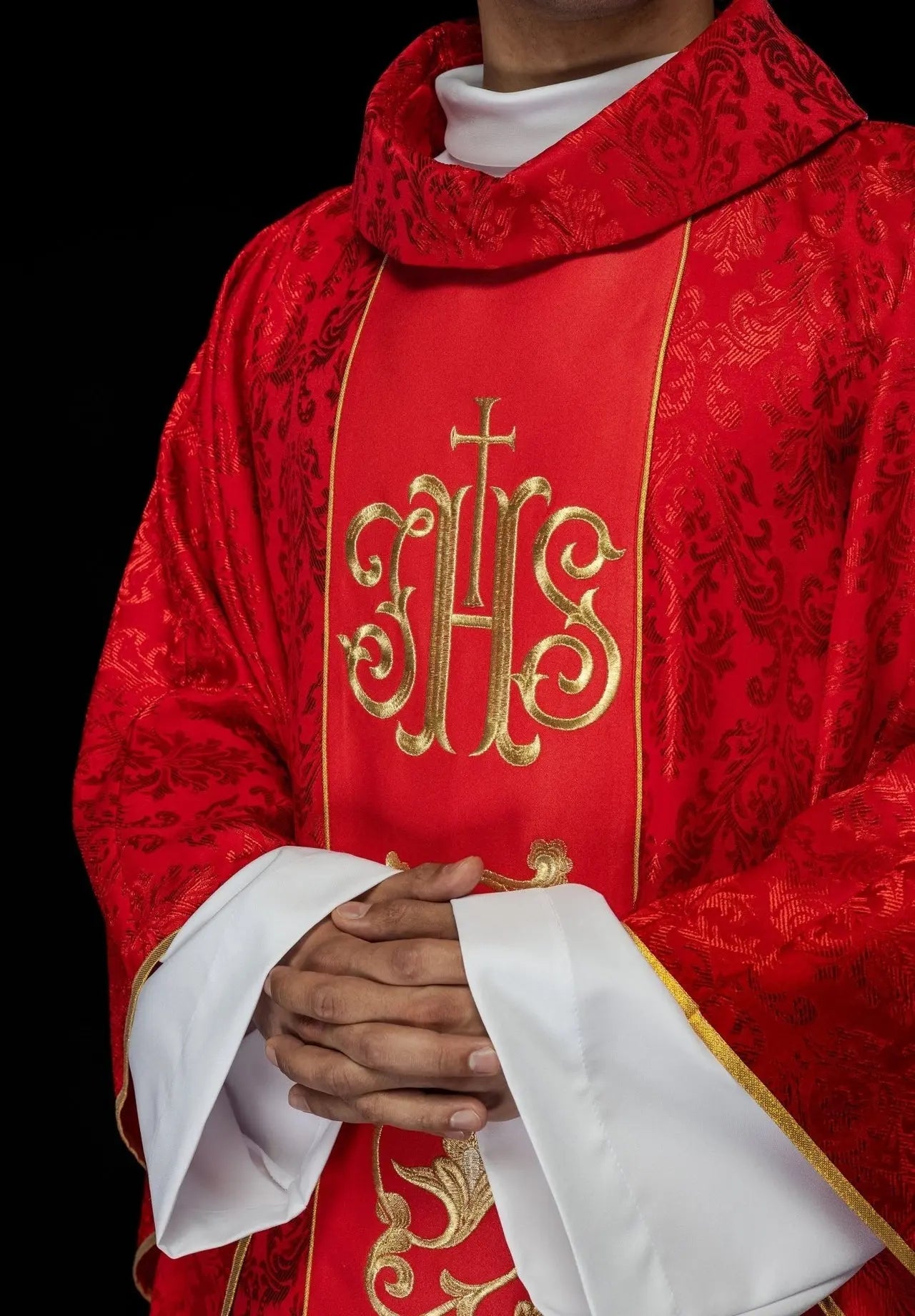 Red liturgical chasuble with richly decorated IHS belt