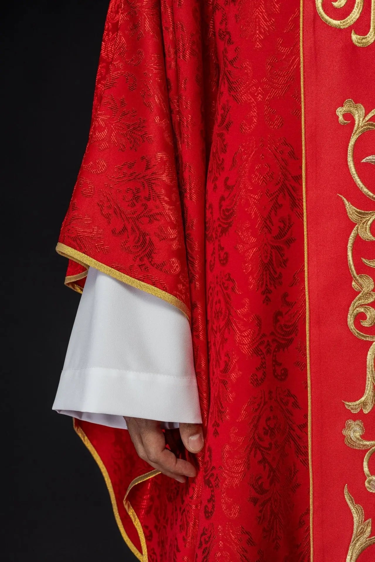 Red liturgical chasuble with richly decorated IHS belt
