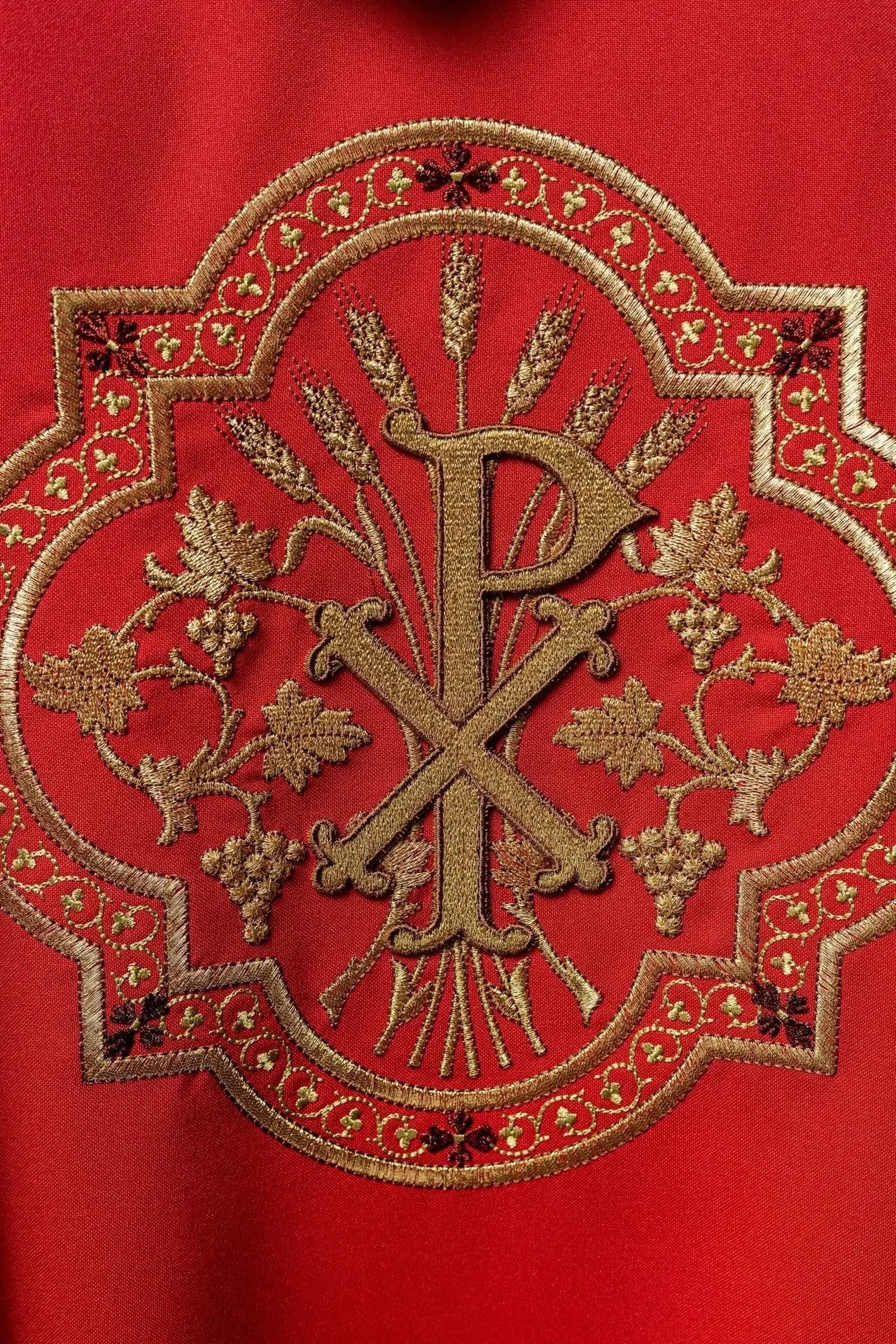 Red chasuble with IHS and PAX embroidery