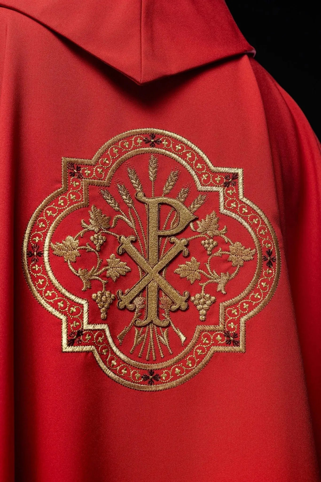 Red chasuble with IHS and PAX embroidery