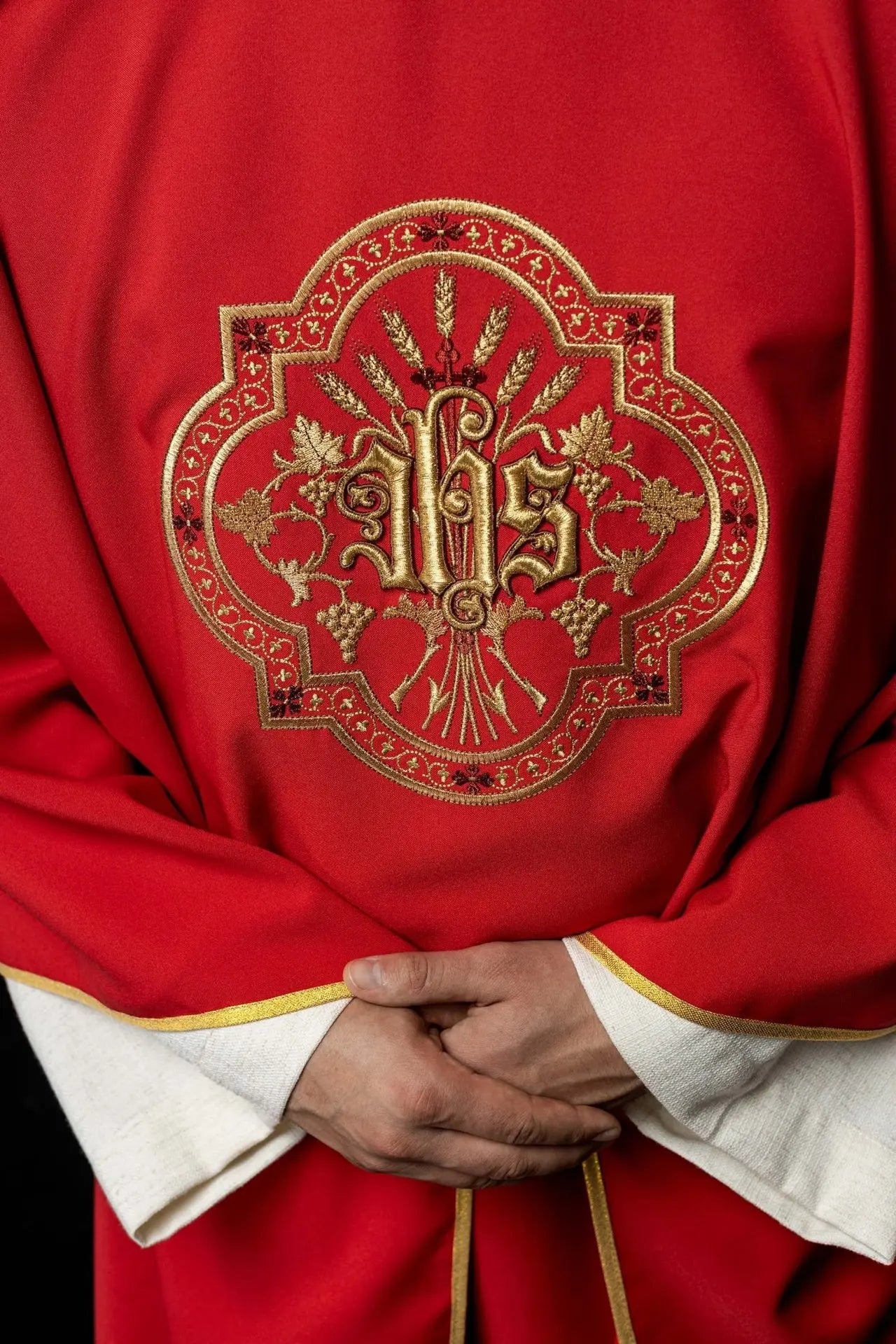 Red chasuble with IHS and PAX embroidery