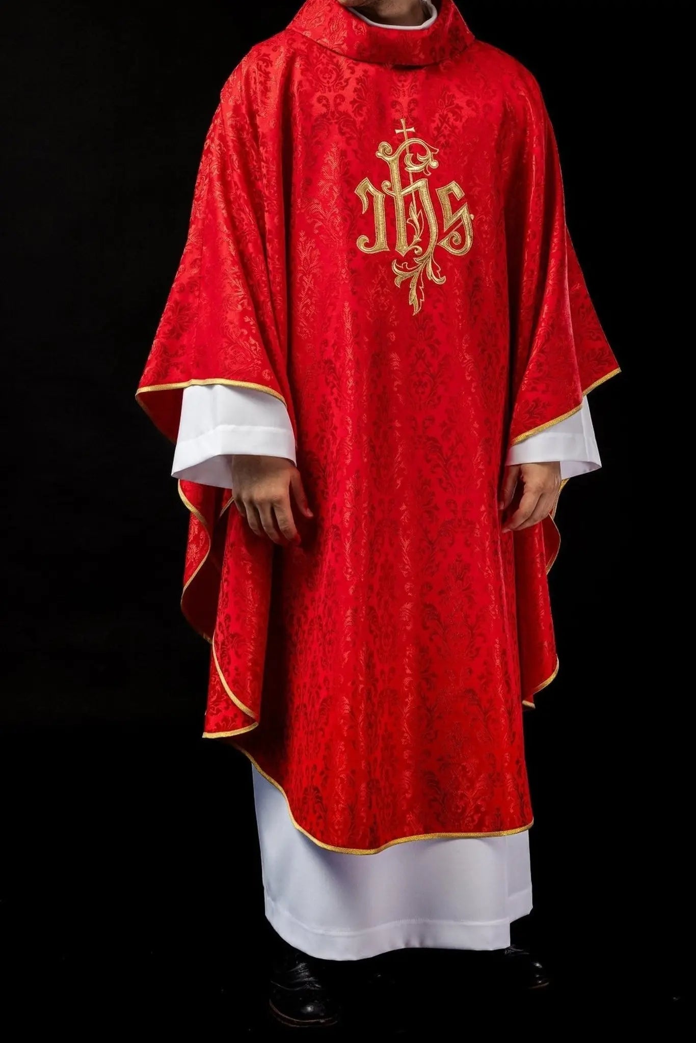 Red chasuble with embroidered IHS motif on decorative fabric