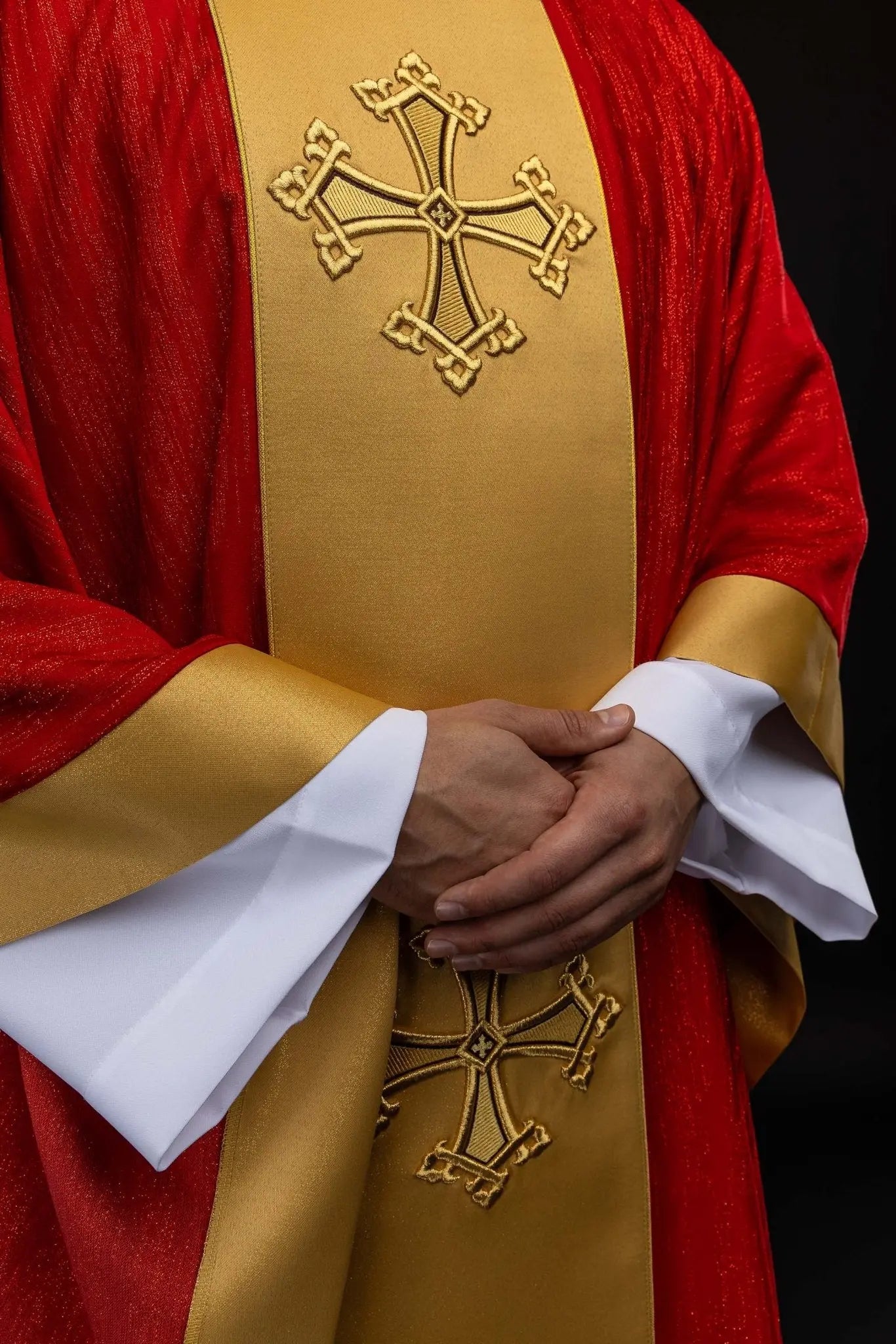 Red chasuble with embroidered cross motif and decorative gold band