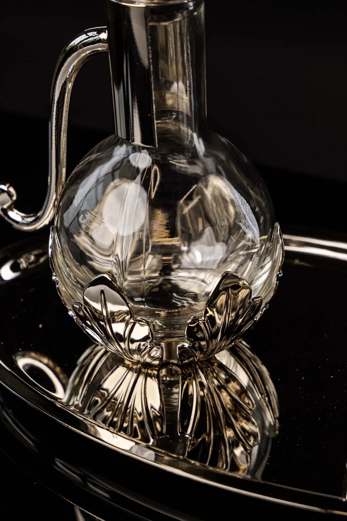 Silver liturgical cruet with floral base, handle, and tray, detail view