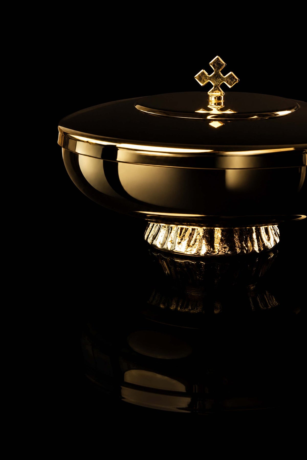 Gold-plated ciborium with decorative cross, angled side view