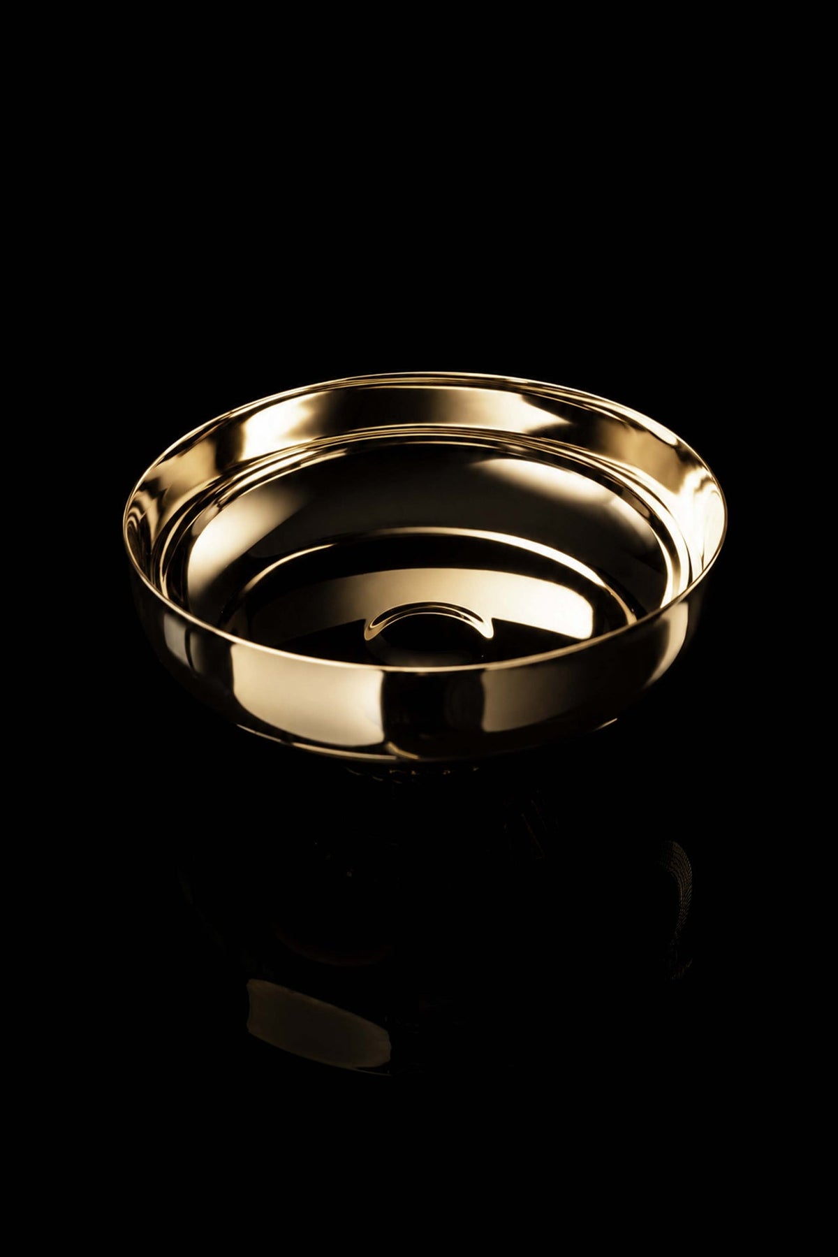 Gold paten with raised rim, angled top view