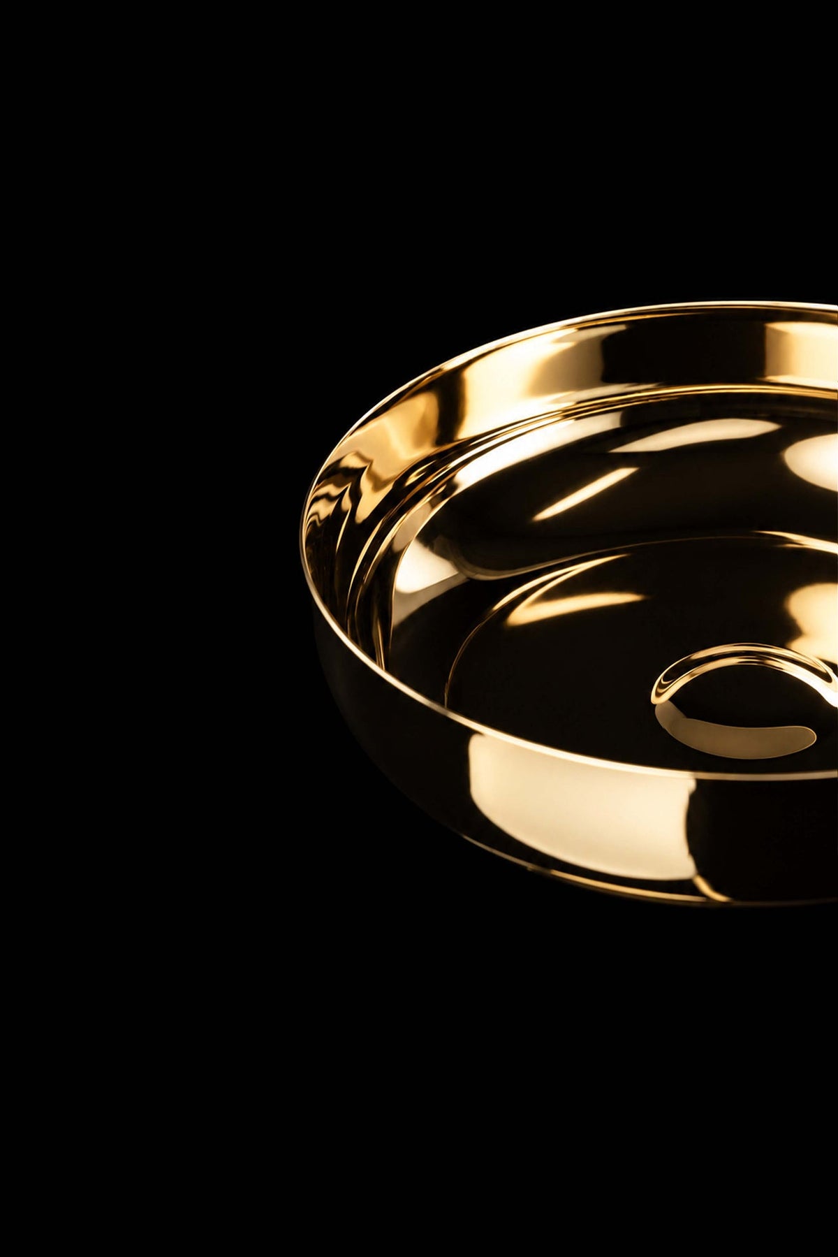 Gold paten with raised rim and center detail, close-up top view