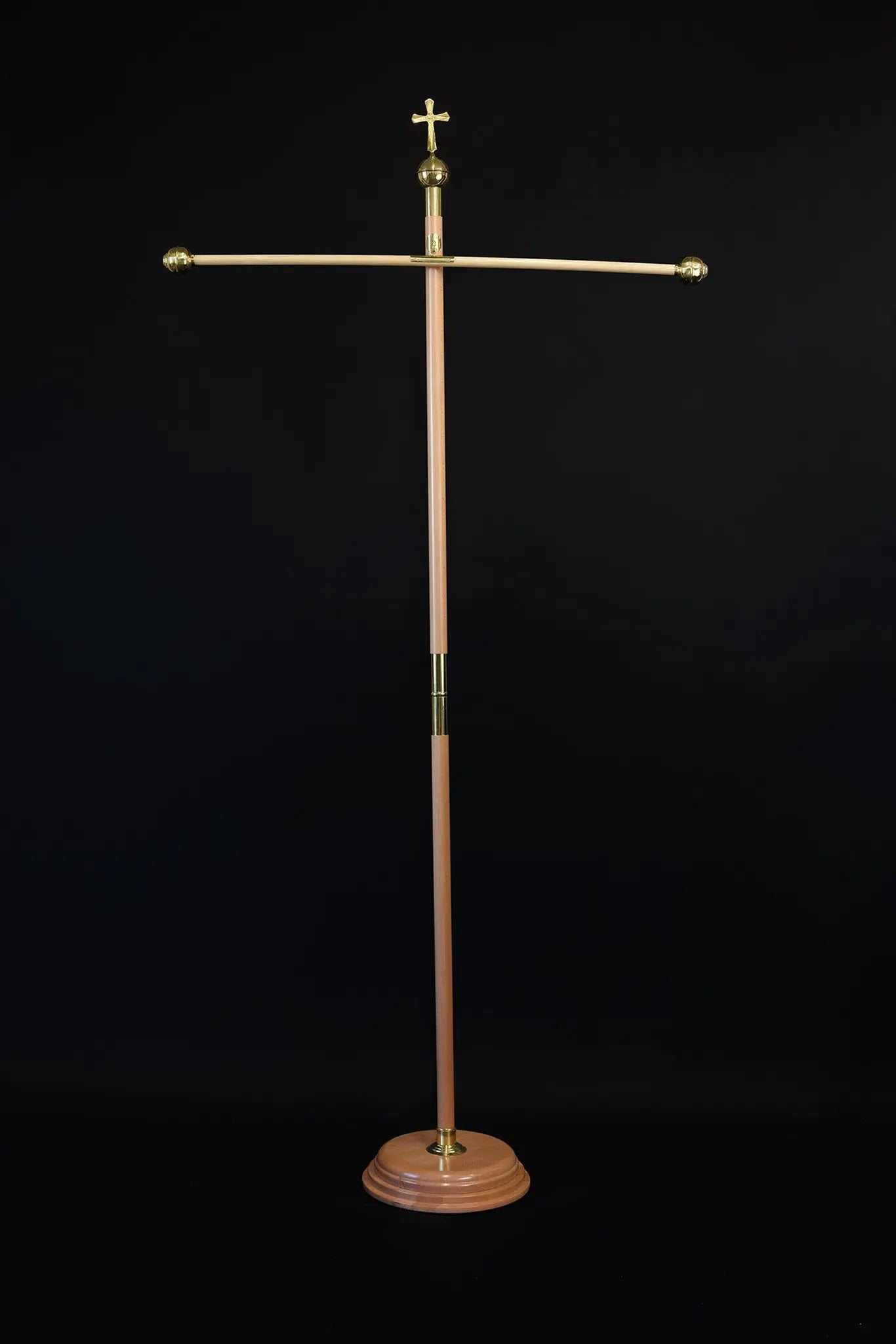 Light wood processional banner pole with decorative cross and gold metal accents