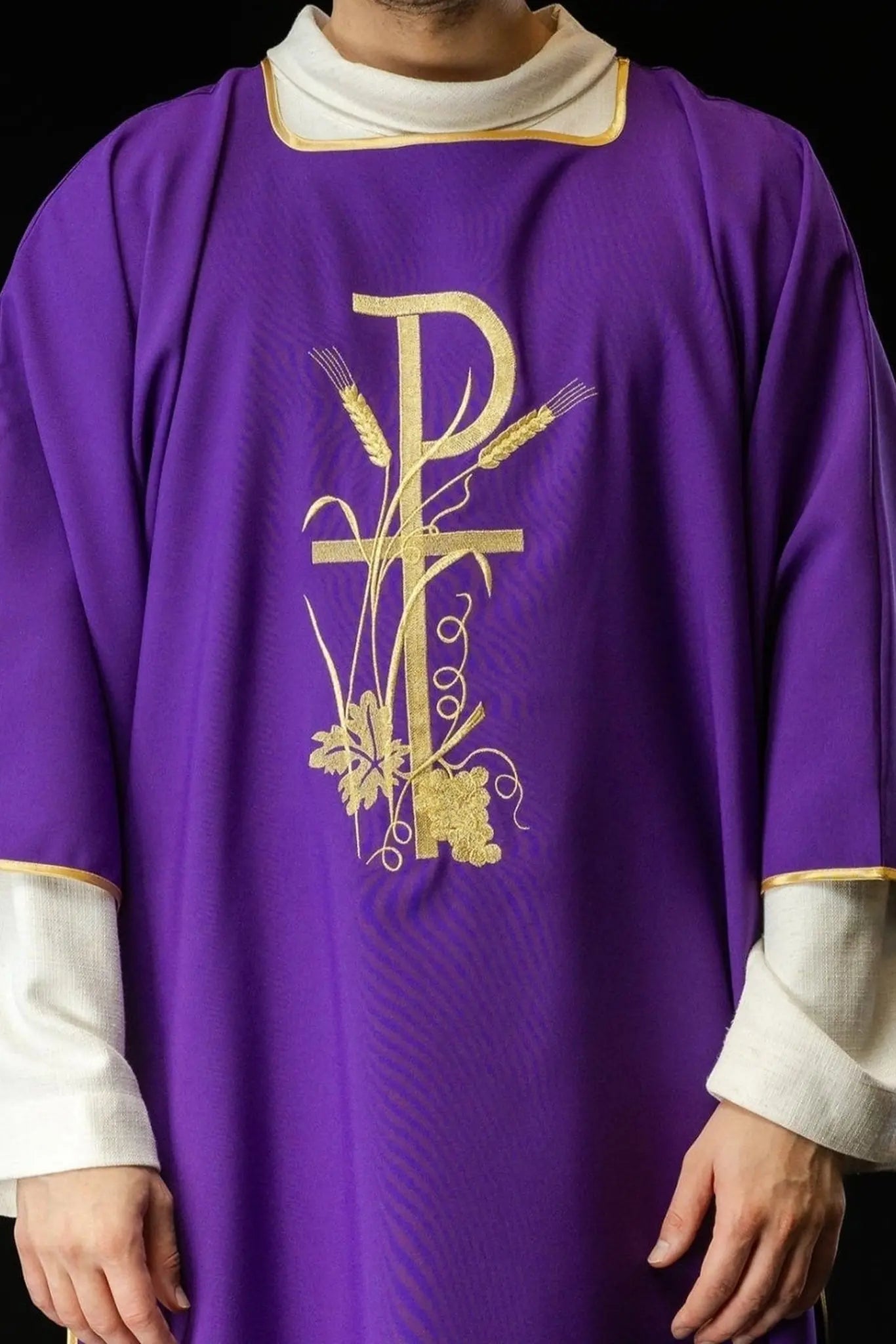Purple dalmatica with gold Pax cross embroidery