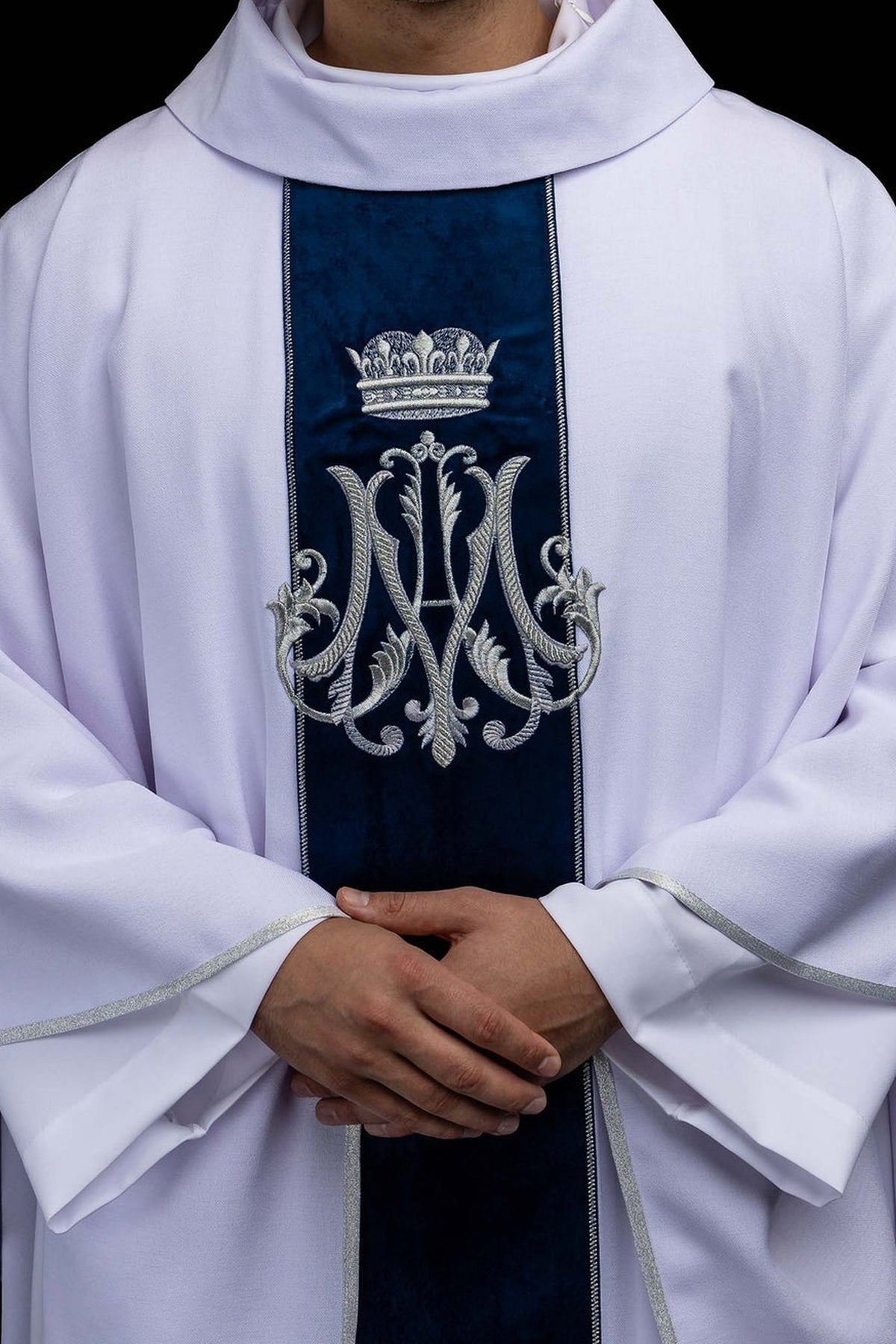 White chasuble with embroidered crowned Marian monogram, front close-up