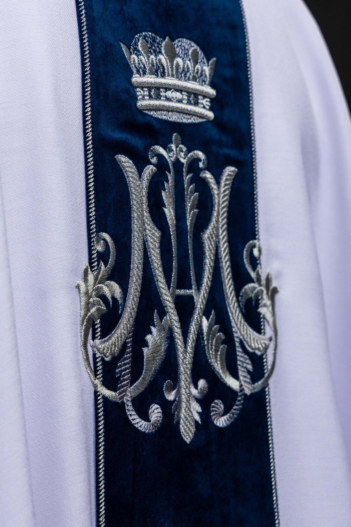 White velvet orphrey with embroidered crowned Marian monogram, close-up