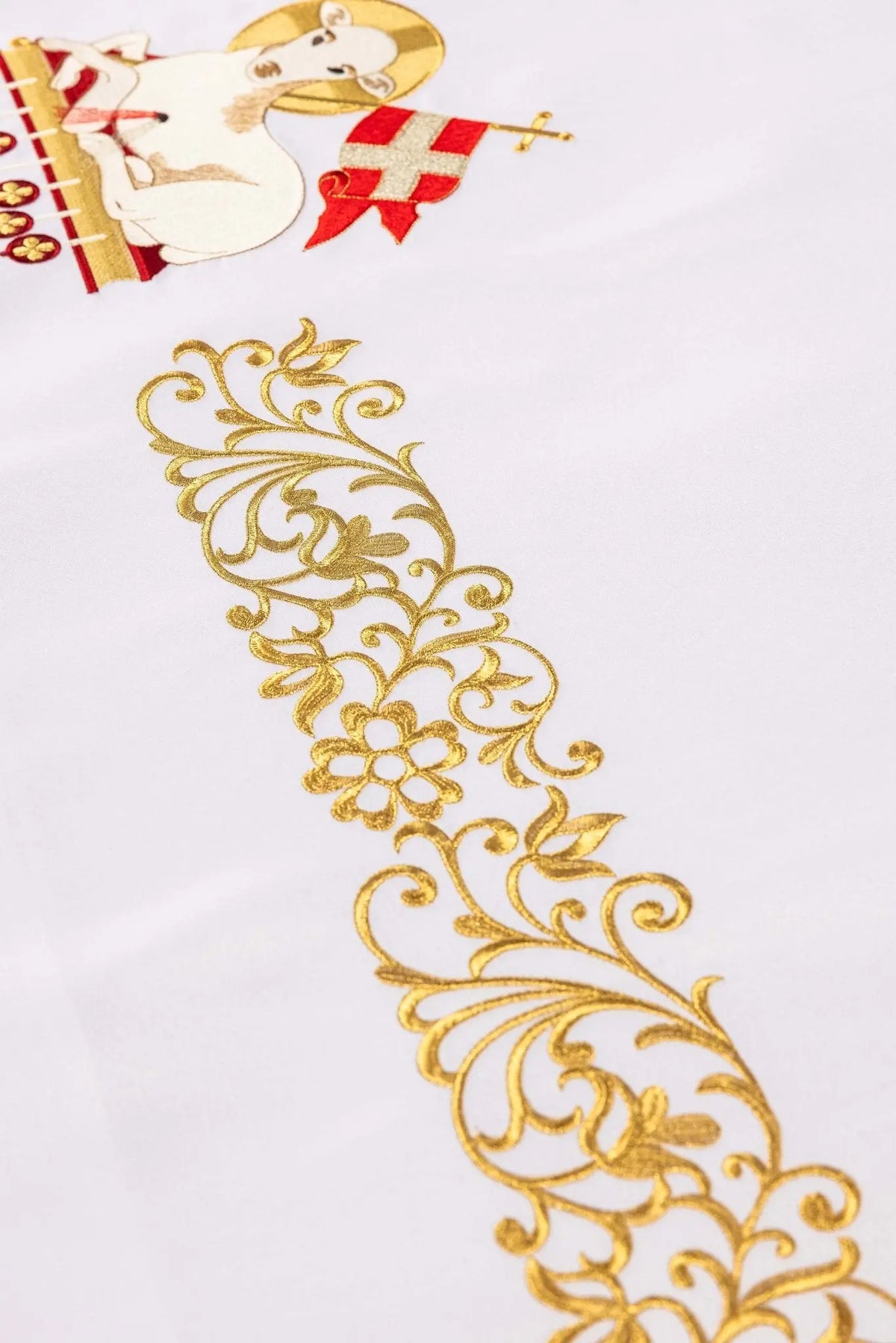 White altar cloth with gold floral embroidery, close-up view
