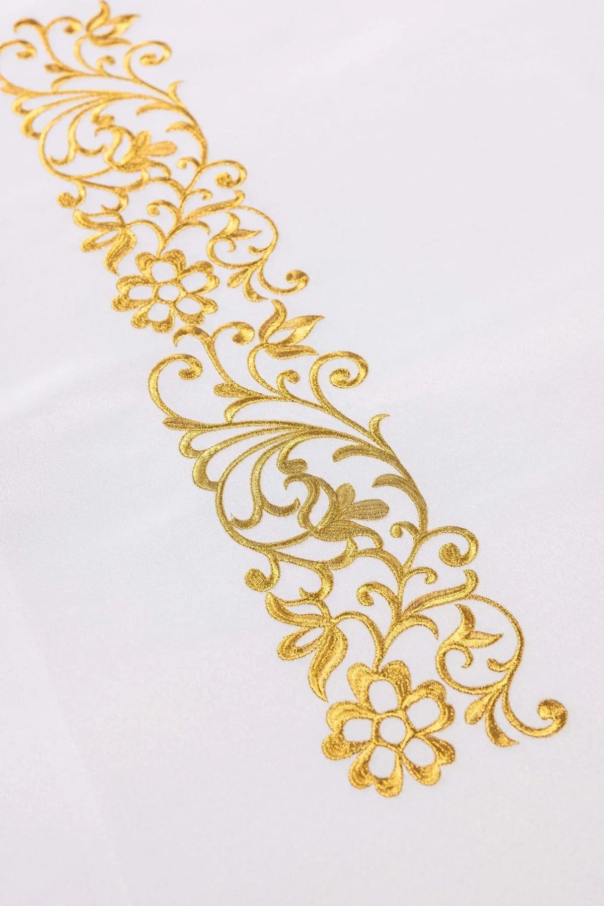 White altar cloth with gold floral embroidery, detail view