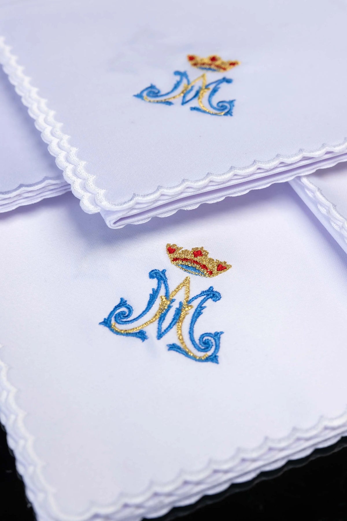 White corporal set with crowned Marian monogram and scalloped edges, close-up view
