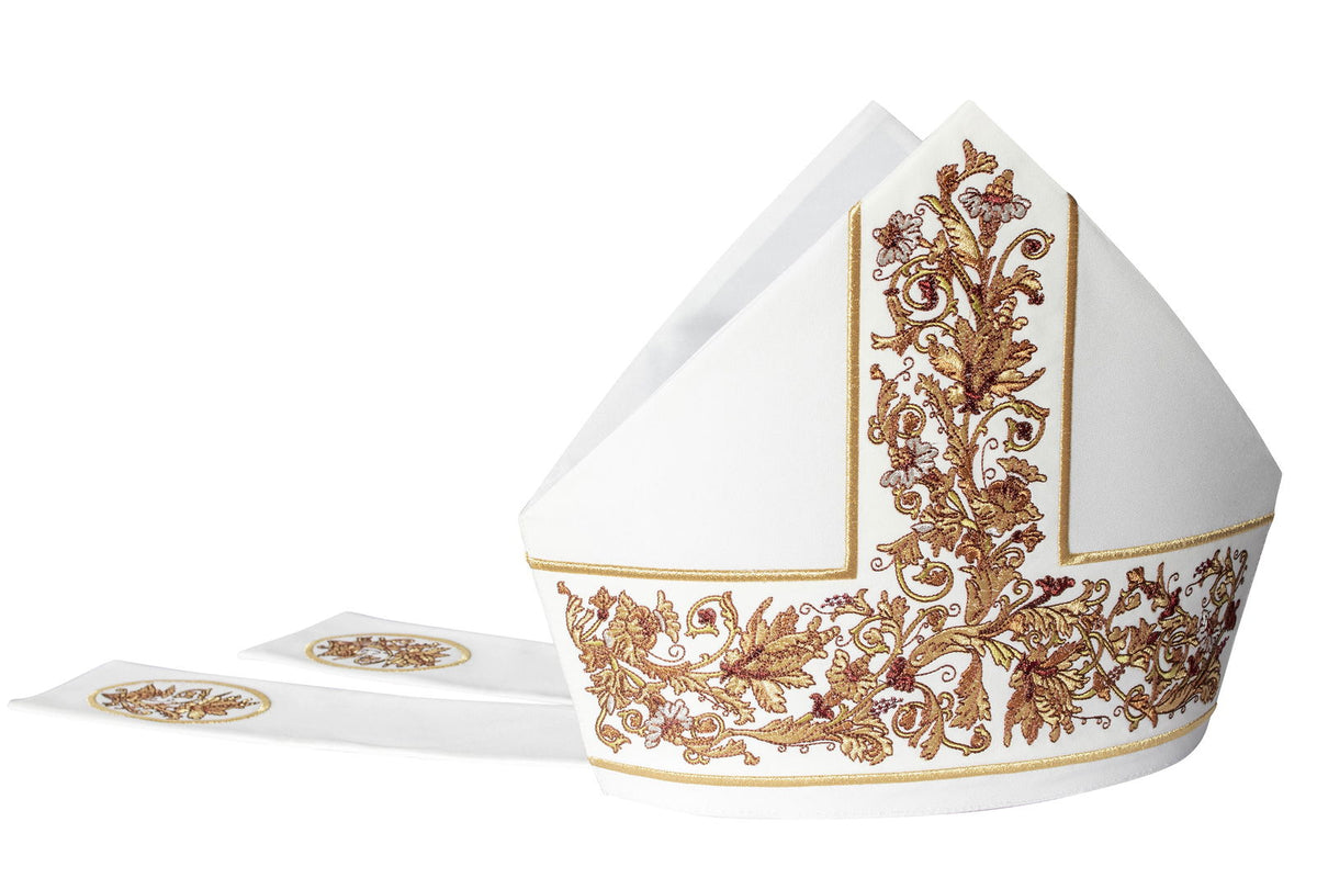 White miter with rich embroidered floral motif, front view