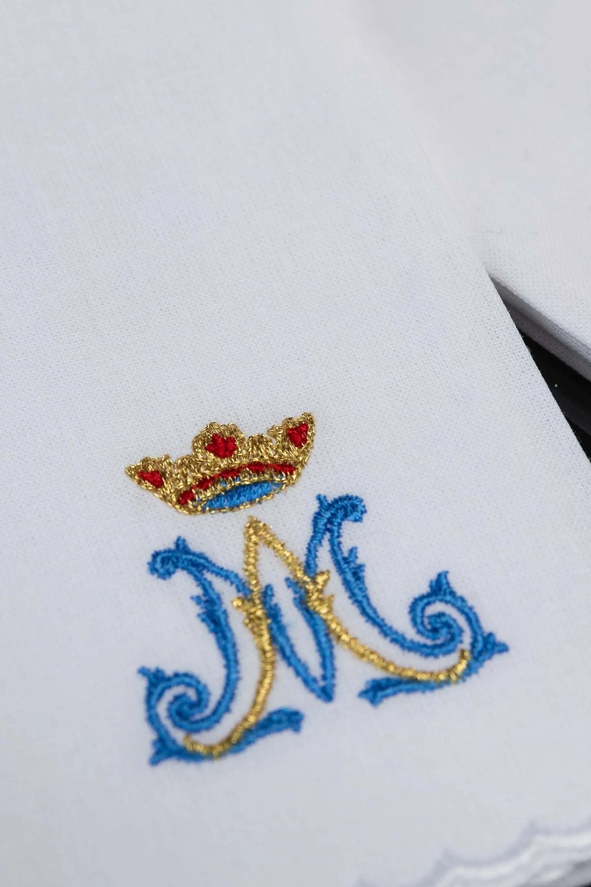White purificator with Marian “M” monogram and crown, embroidery close-up