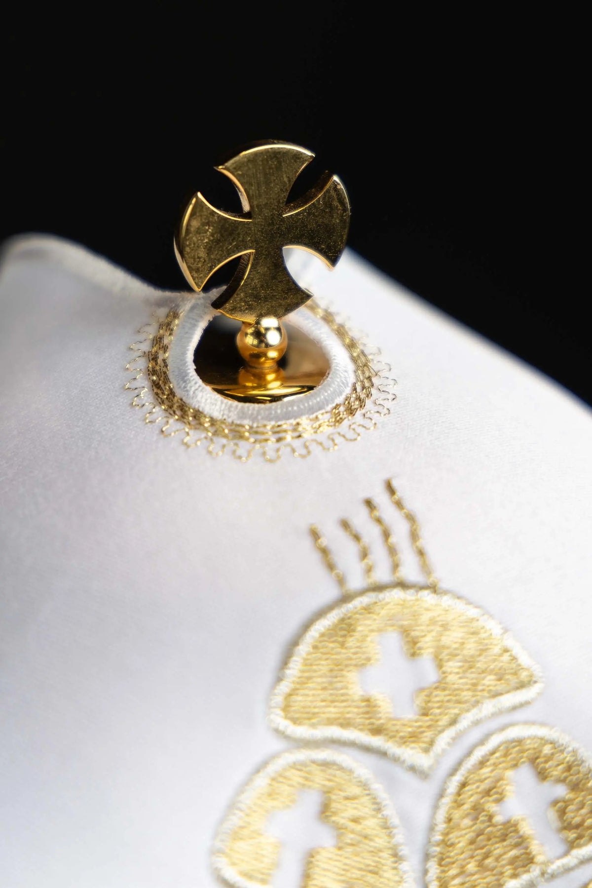 White ciborium veil with gold bread and fish embroidery, cross finial close-up