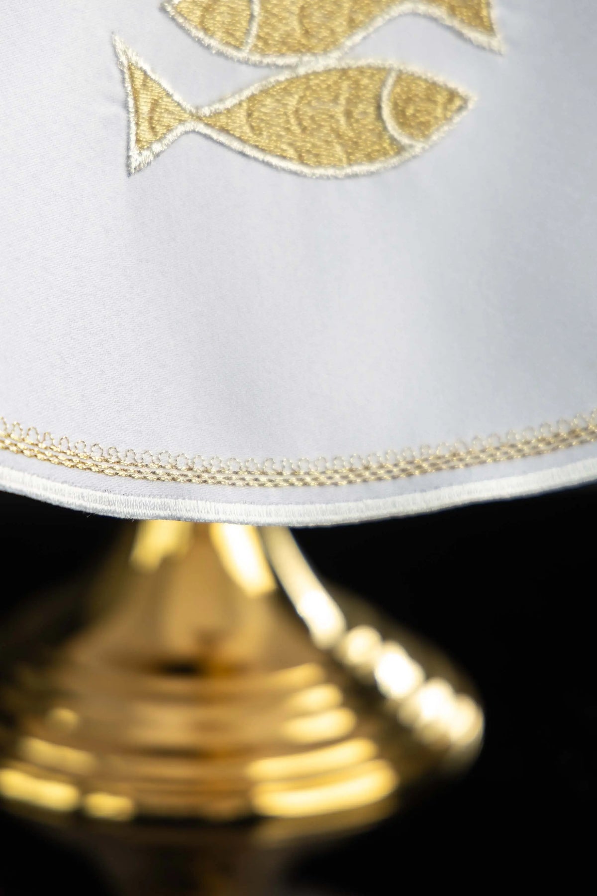White ciborium veil with gold fish embroidery and trimmed hem, close-up view