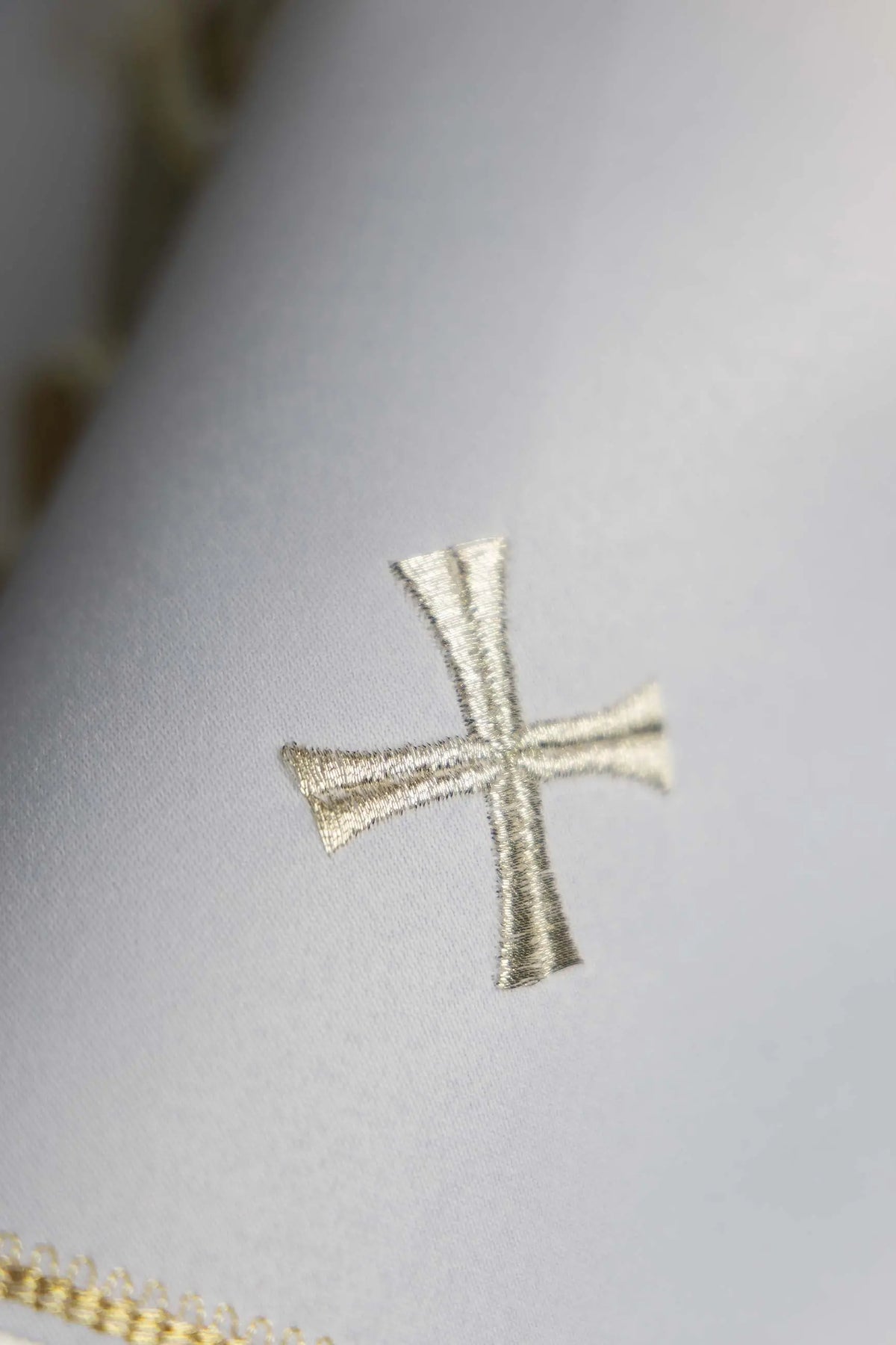 White ciborium veil with silver cross and gold trim, detail view
