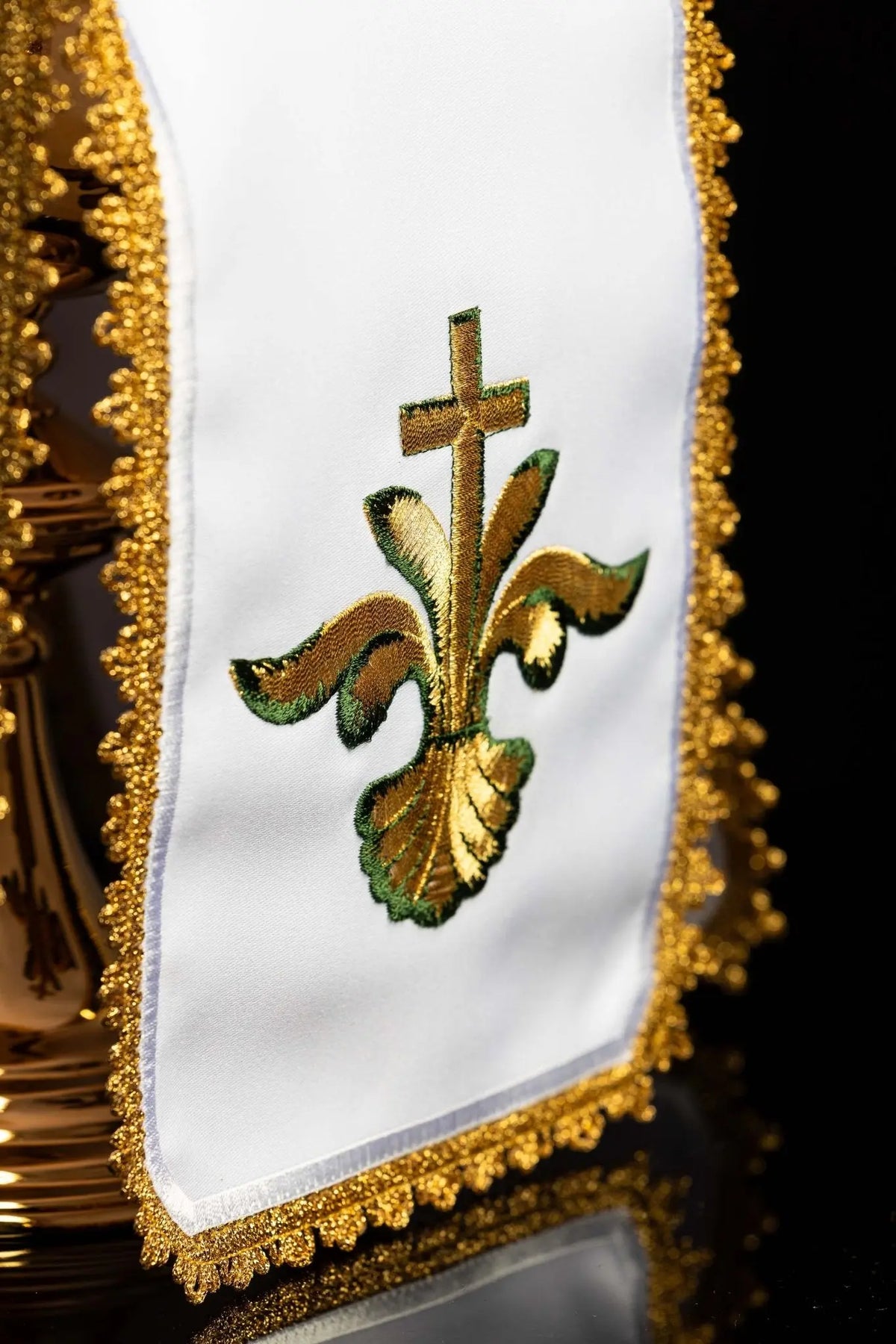 White ciborium veil with gold floral cross embroidery, close-up view