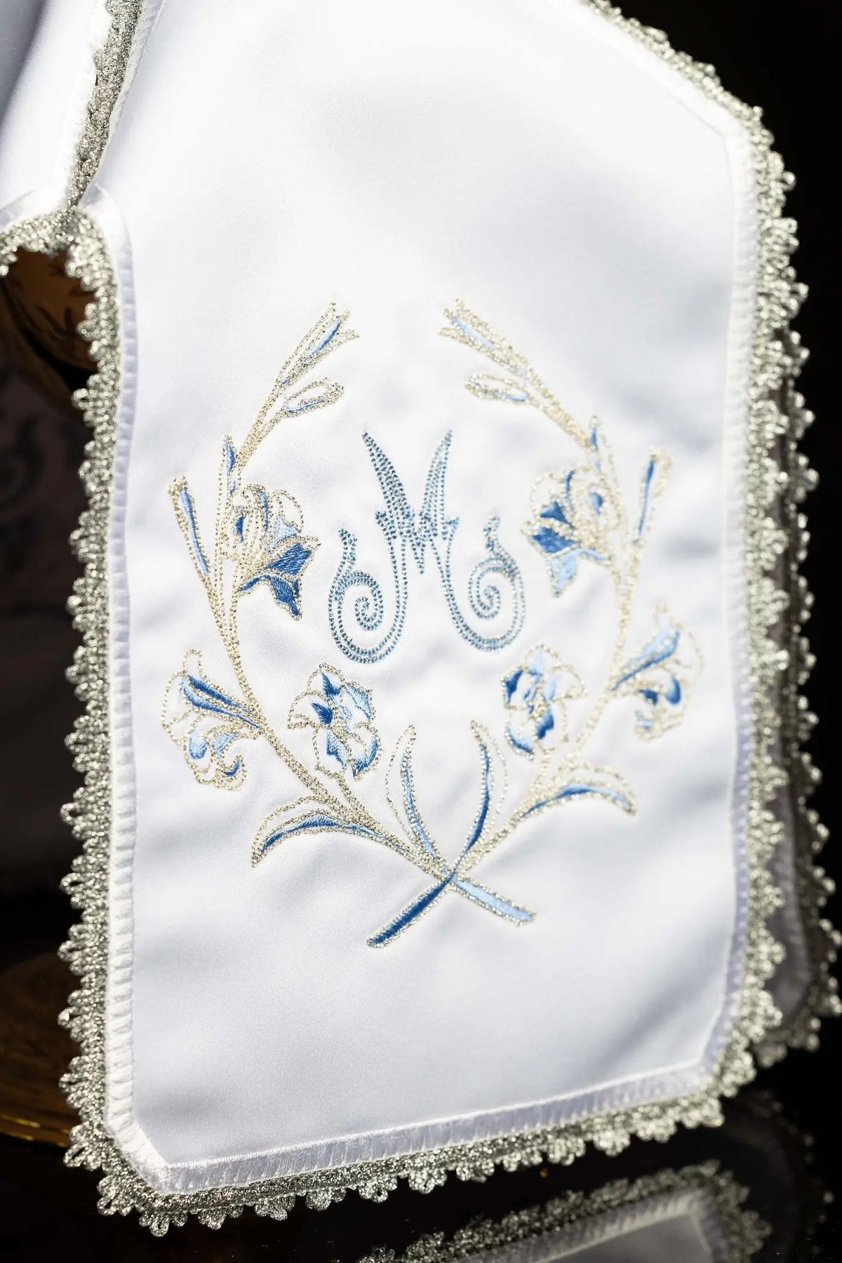 White ciborium veil with silver Marian embroidery, close-up of blue and silver floral motif