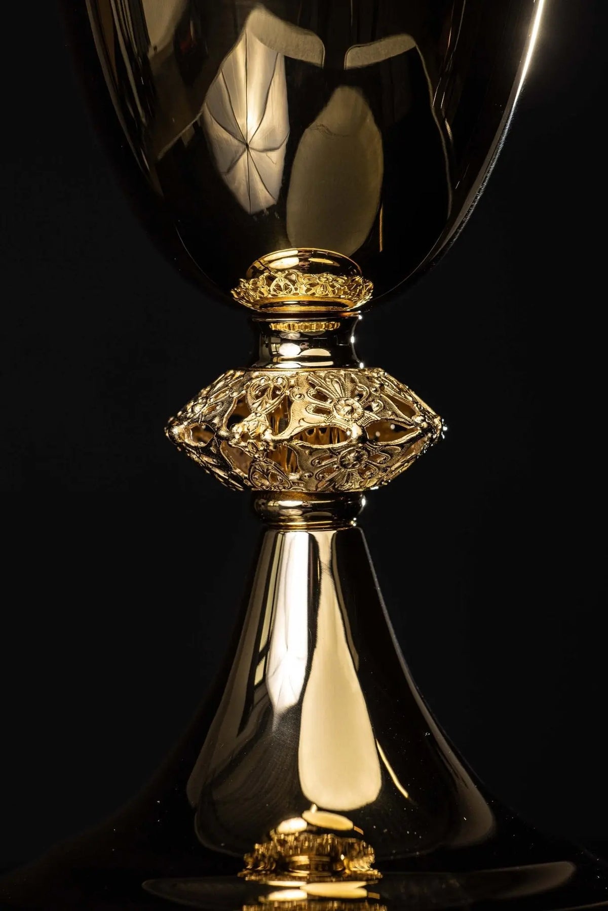 Gold-plated brass chalice with openwork floral ornament, close-up view