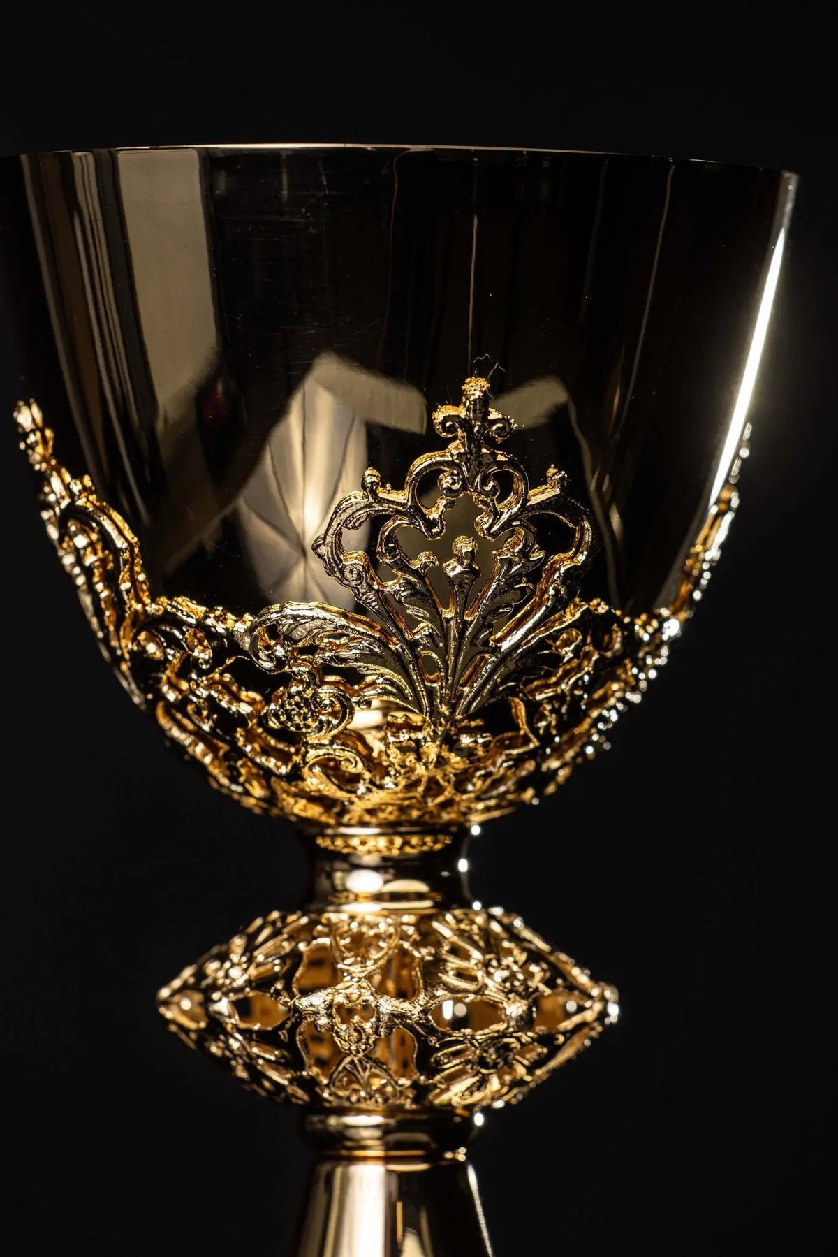 Gold-plated brass chalice with floral ornament, ornate cup close-up