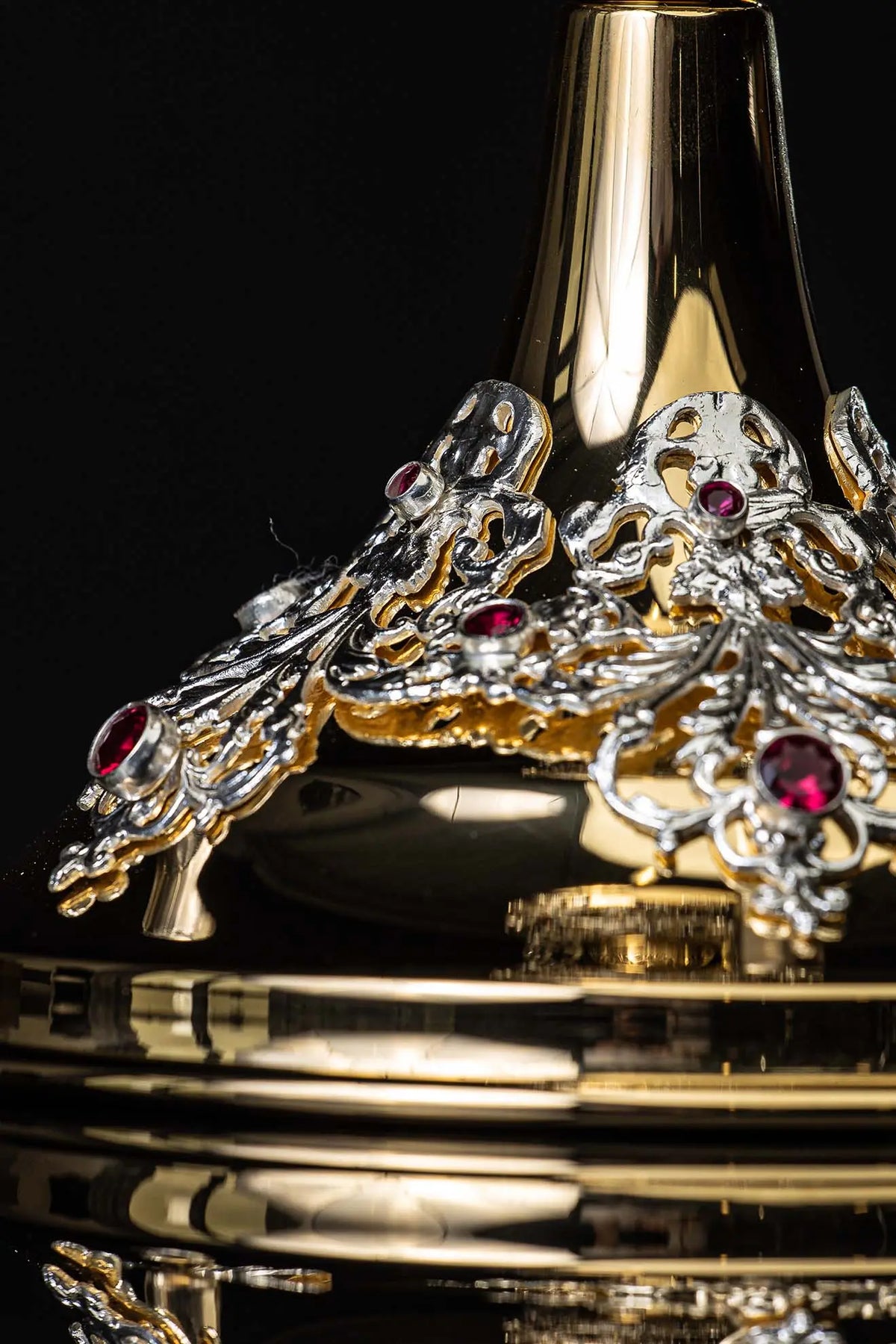 Gold chalice with openwork plant ornaments and rubies, lower base close-up