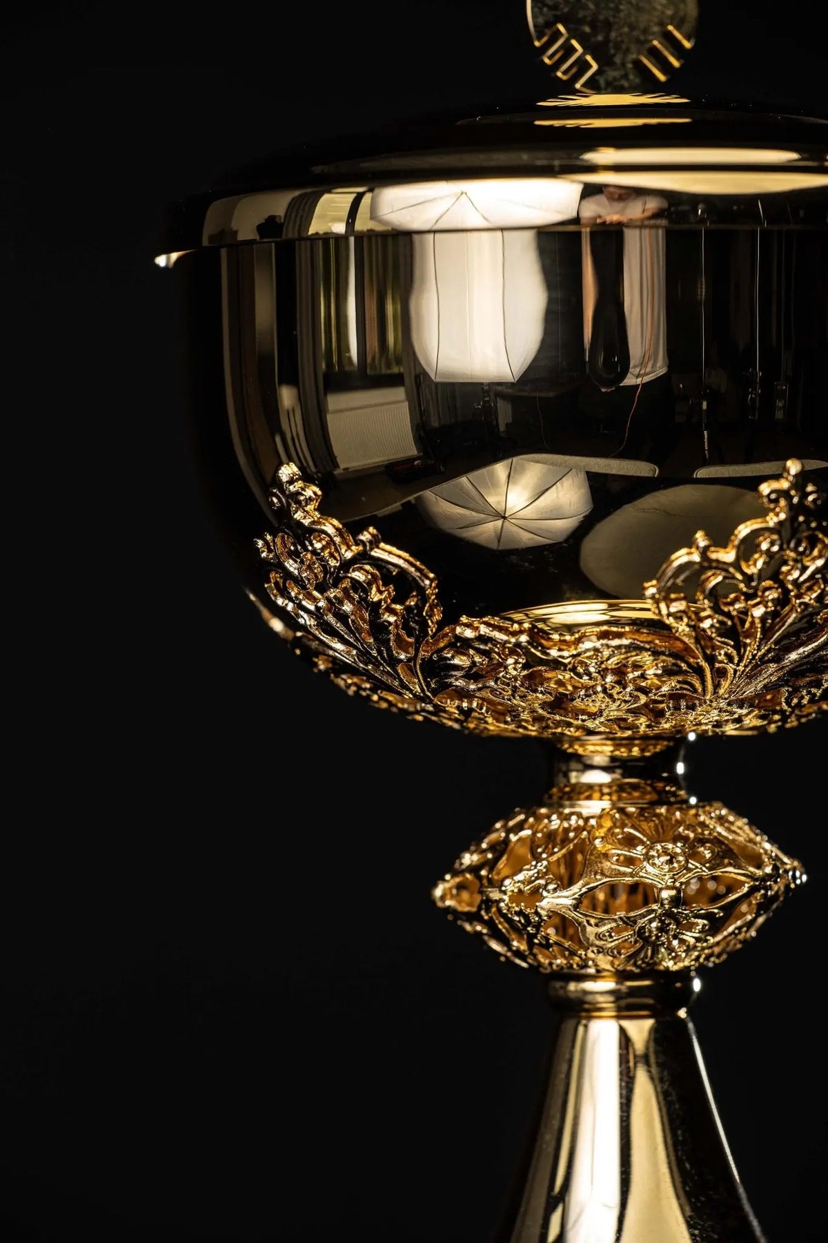 Gold ciborium with floral ornaments, angled close-up of the bowl