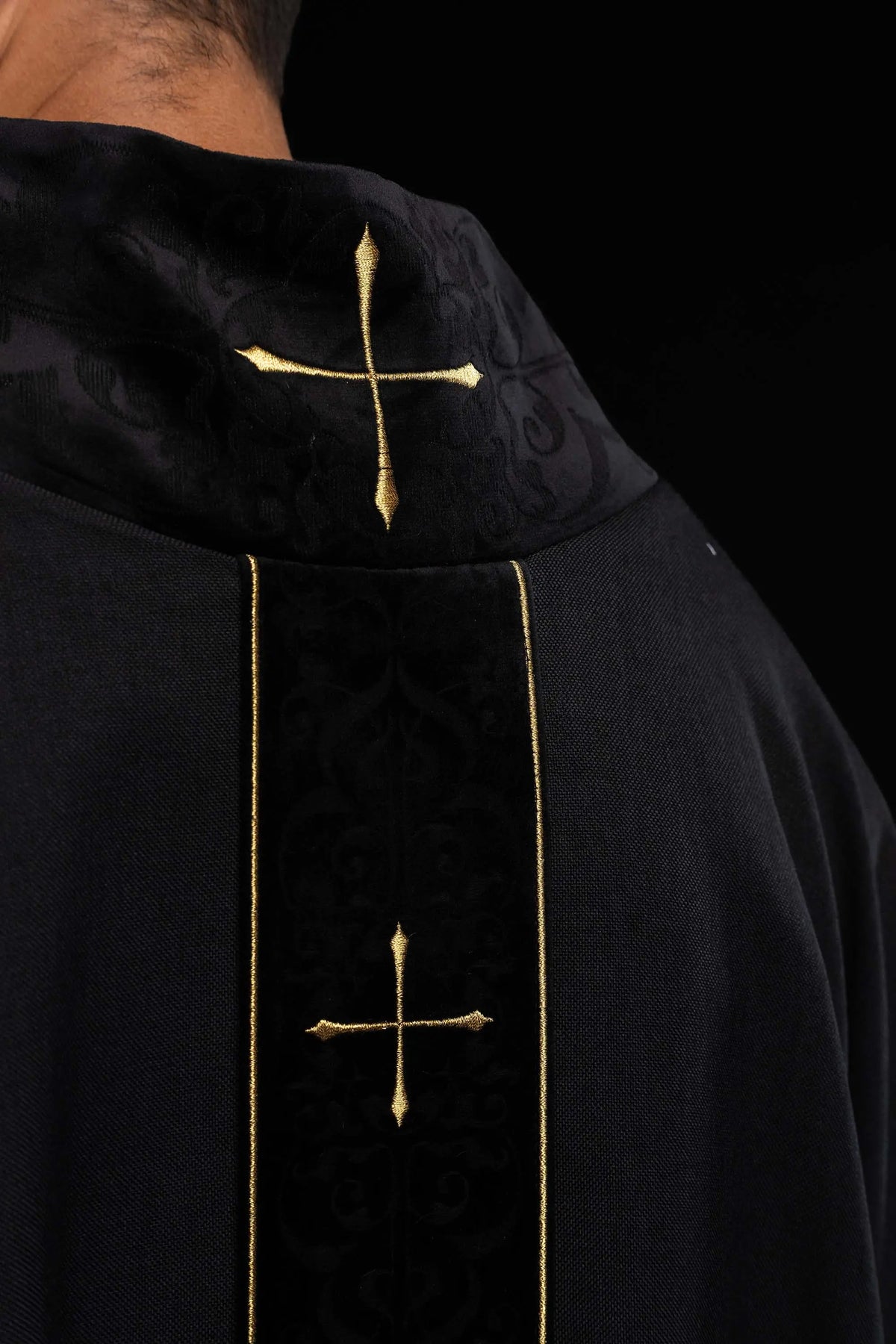 Black chasuble with gold crosses, collar and central panel close-up