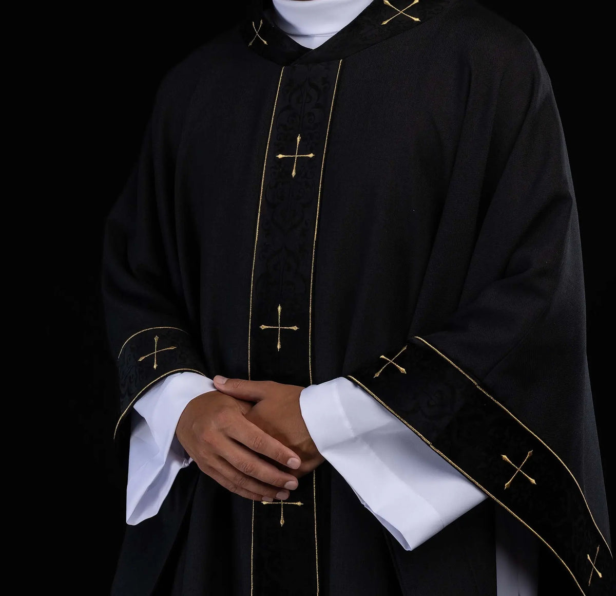 Black chasuble with gold crosses, front worn view with sleeves