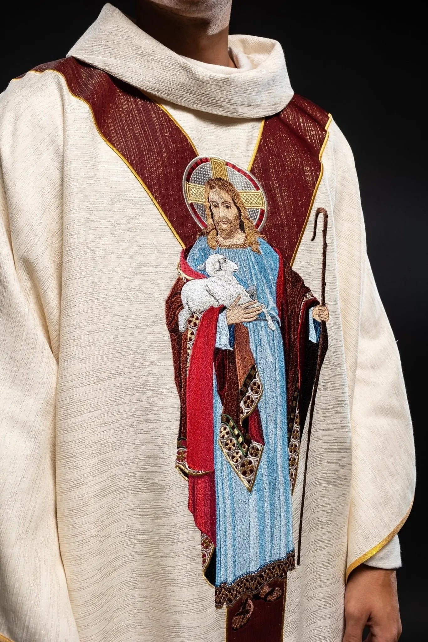 Chasuble ecru with the image of Jesus the Good Shepherd with a decorative burgundy stripe