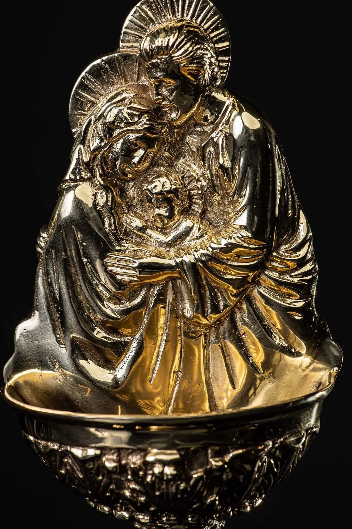 Gold and silver holy water font with the Holy Family, close-up front view