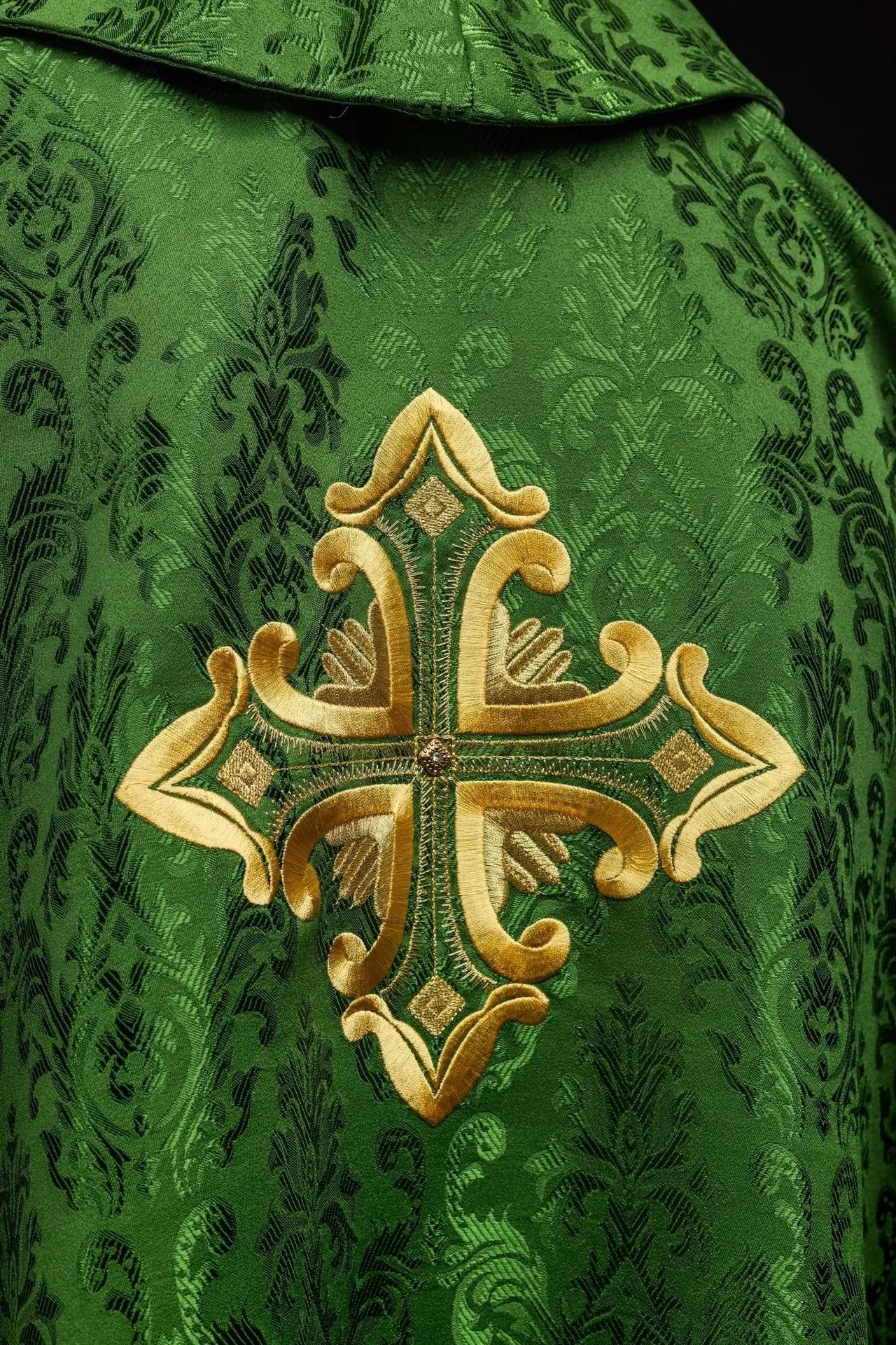 Green chasuble with cross sewn from patterned fabric