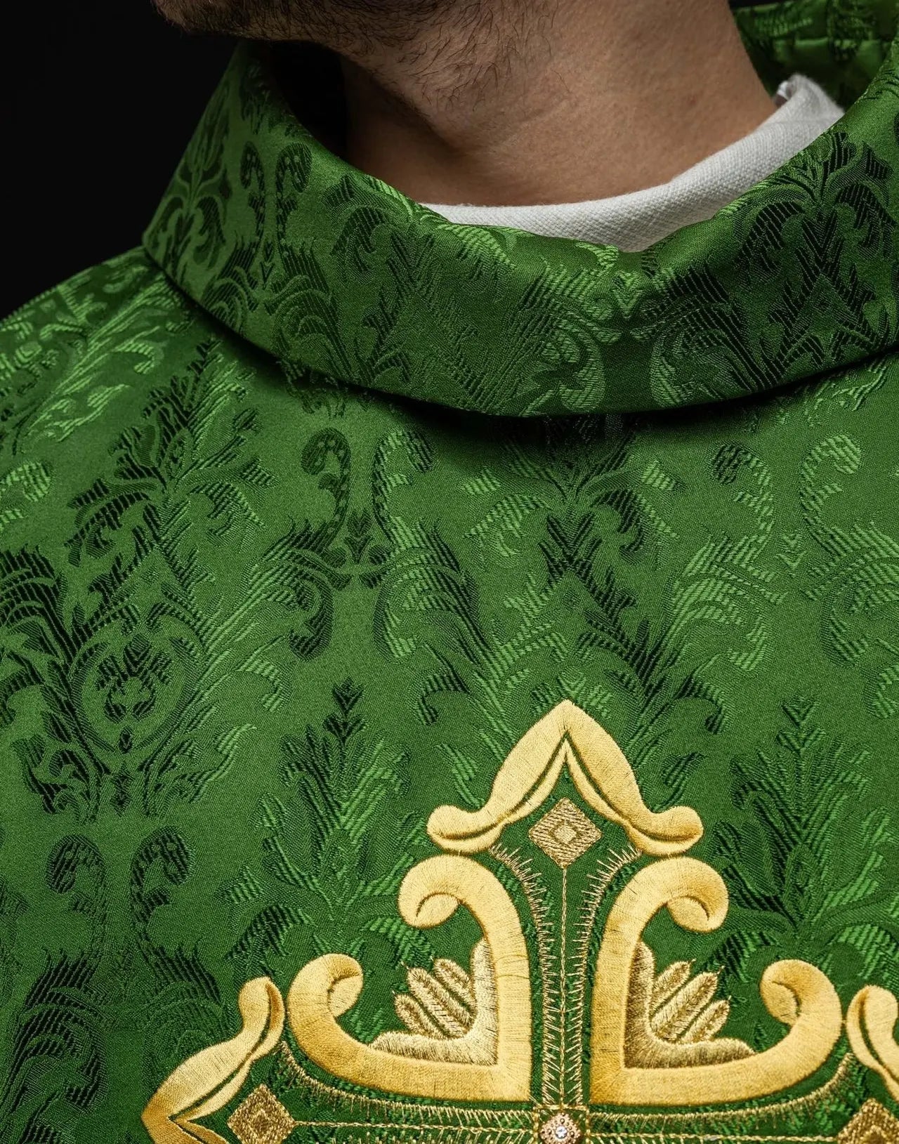Green chasuble with cross sewn from patterned fabric