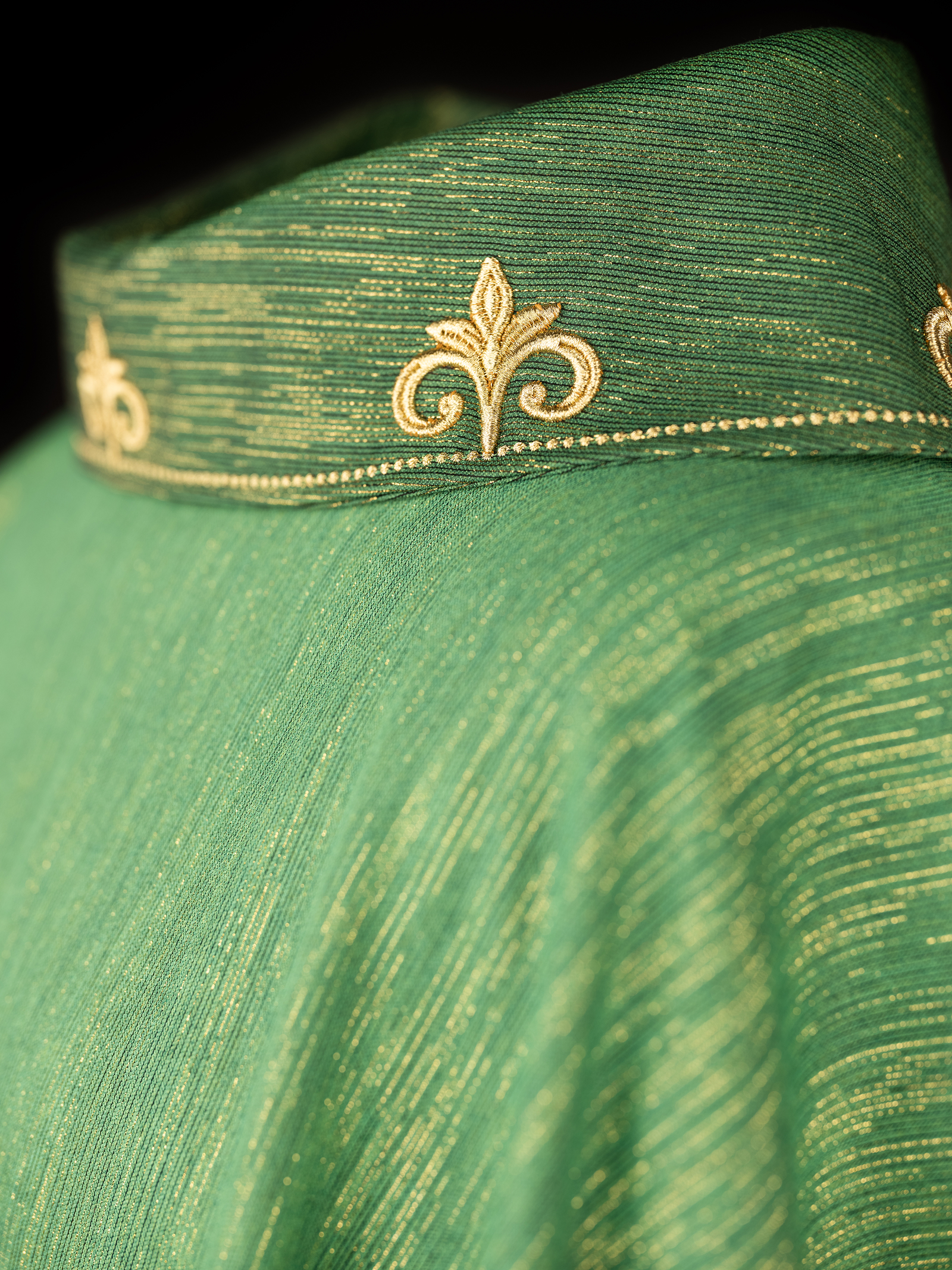 Green chasuble with richly embroidered cross and decorated collar