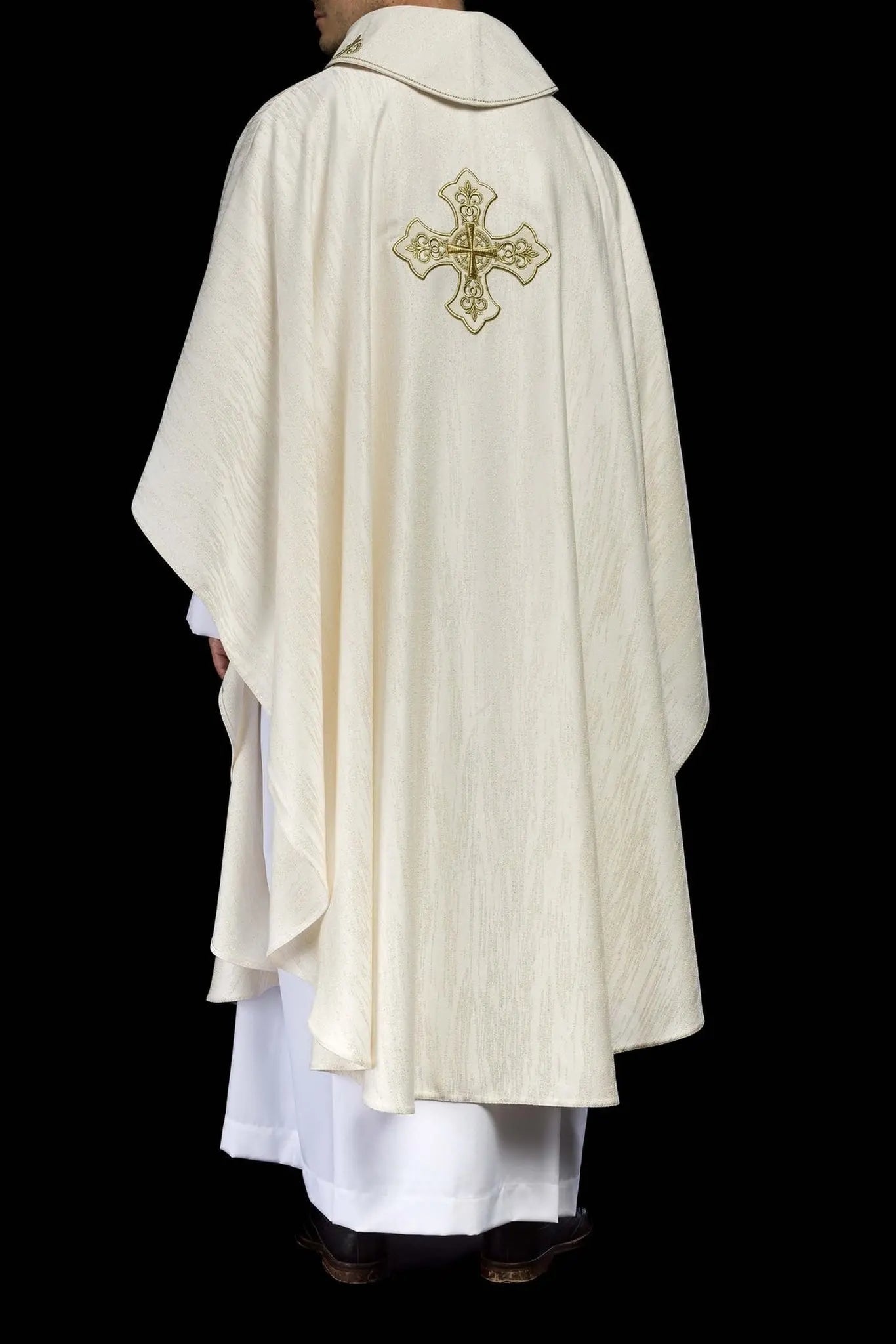 Ecru liturgical chasuble with an embroidered cross motif on decorative fabric