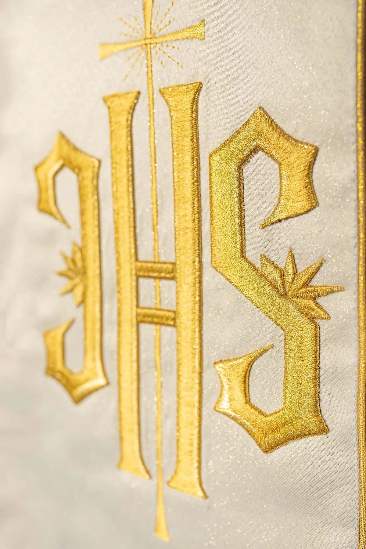 Richly decorated gold chasuble with a gold motif and a wide IHS embroidered band