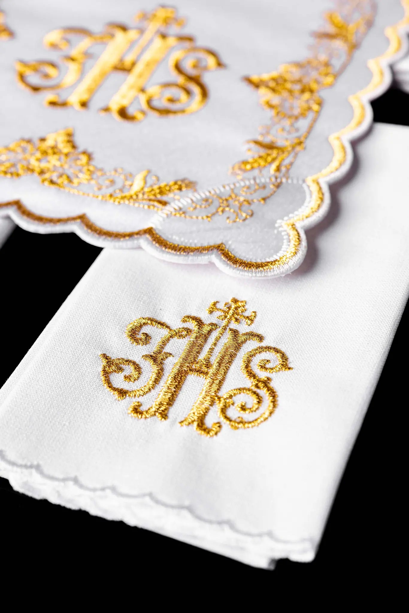 White chalice linen set with IHS embroidery on pall, purificator, and lavabo towel.
